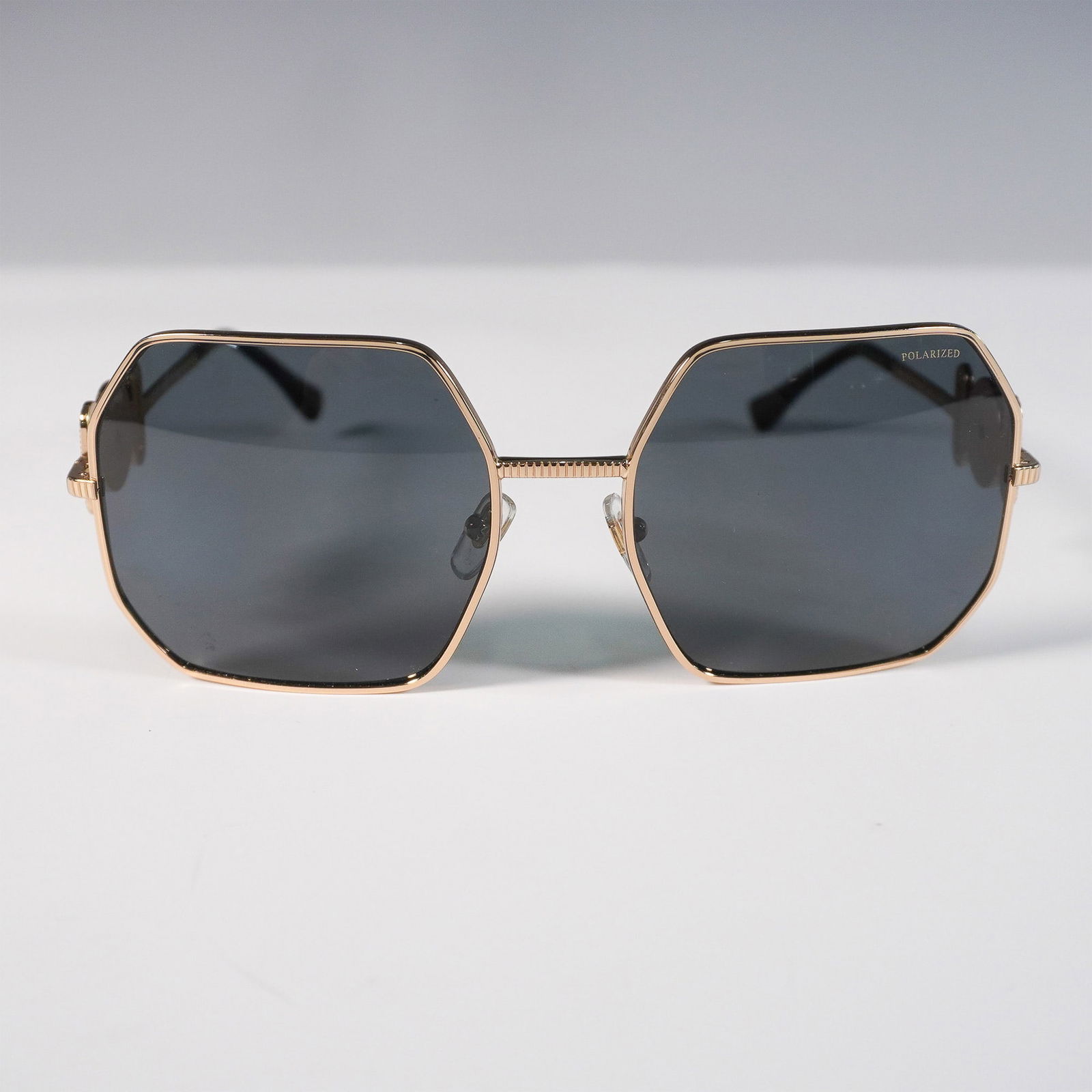 Versace Medusa Biggie Sunglasses, MOD. 2248: Versace Medusa Biggie sunglasses featuring striking heptagon-shaped dark grey lenses with a bold, fashion-forward silhouette. These irregular-frame sunglasses are crafted with slim gold-tone metal fra
