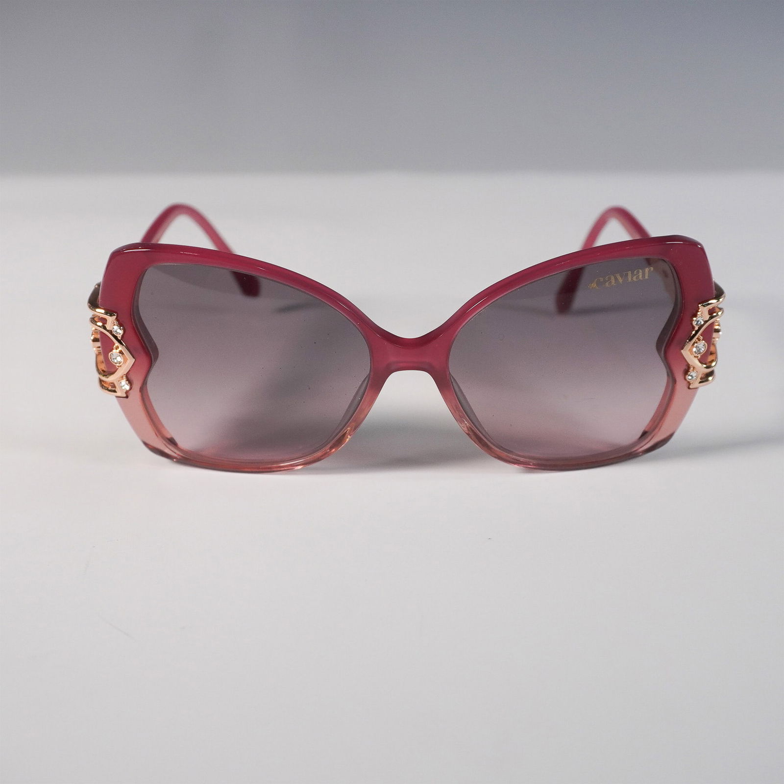 Caviar Champagne Series Sunglasses, Crystal Embellished: Elegant Caviar Champagne Series sunglasses featuring a striking rose gold-tone metal frame with intricate latticework and sparkling crystal embellishments on the temples. The oversized butterfly-shape