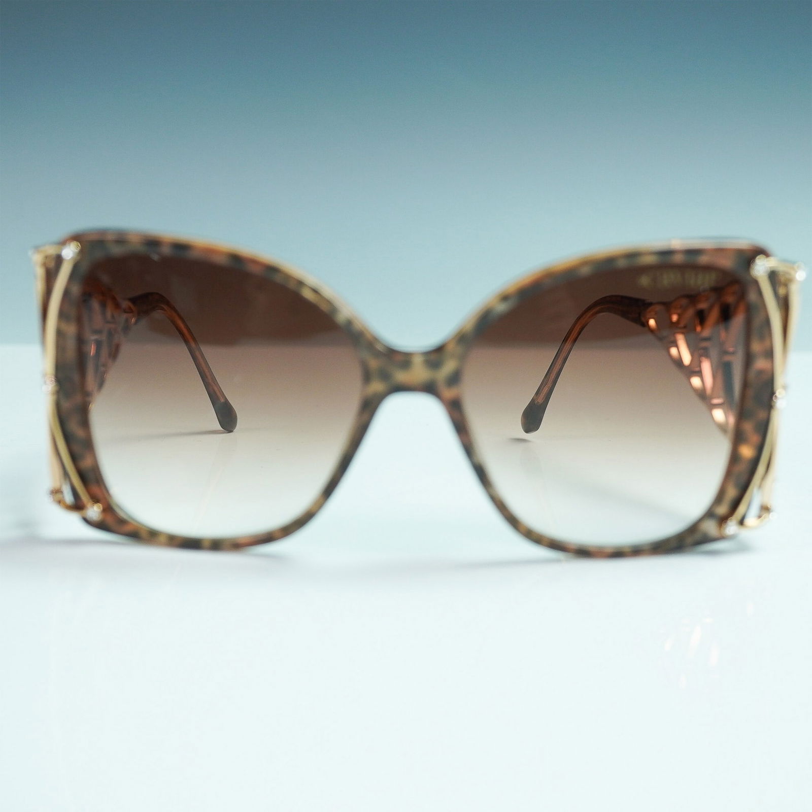 Caviar Sunglasses, Champagne Series Model M6891 C31: Stylish and luxurious, these oversized Caviar sunglasses from the Champagne Series feature a tortoiseshell acetate frame with dramatic gold-tone lattice temples adorned with sparkling rhinestones. The