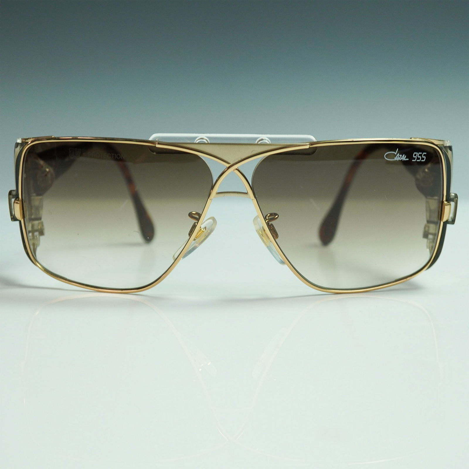 Cazal 955 Vintage Sunglasses - Gold and Tortoiseshell: A highly sought-after pair of vintage Cazal 955 sunglasses, featuring an iconic oversized square frame with gold-tone metal and clear side shields. Designed by the legendary Cari Zalloni, this bold de