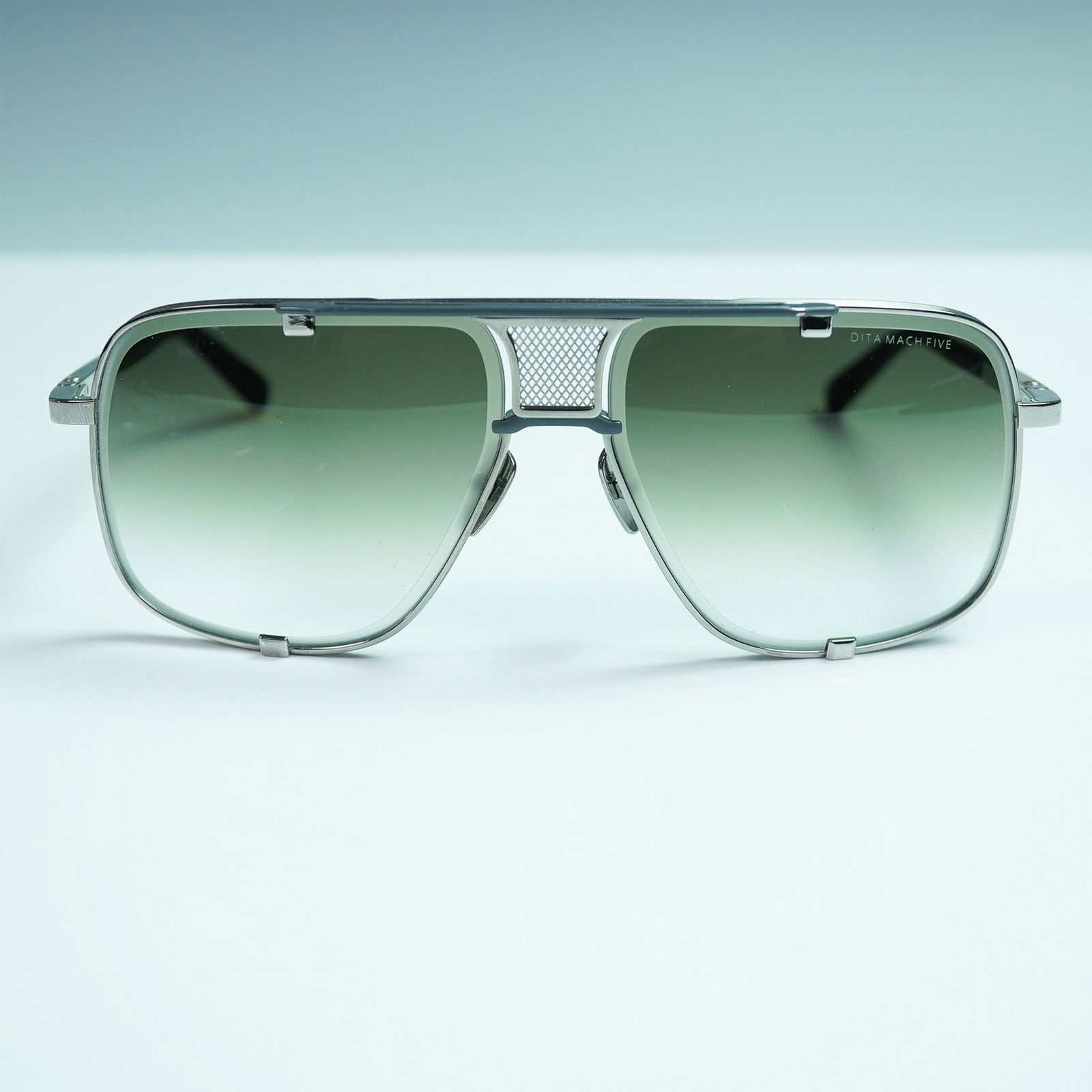 DITA Mach Five Titanium Sunglasses: Inspired by the golden era of single-seat automotive racing, these DITA Mach Five sunglasses represent the fusion of motorsport heritage and cutting-edge eyewear design. Model DRX-2087-G-PLD-BLK-64 is