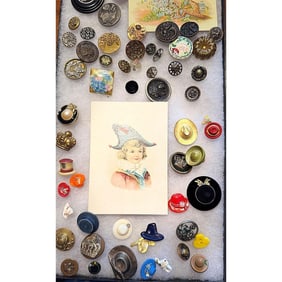A Riker tray of assorted material buttons
