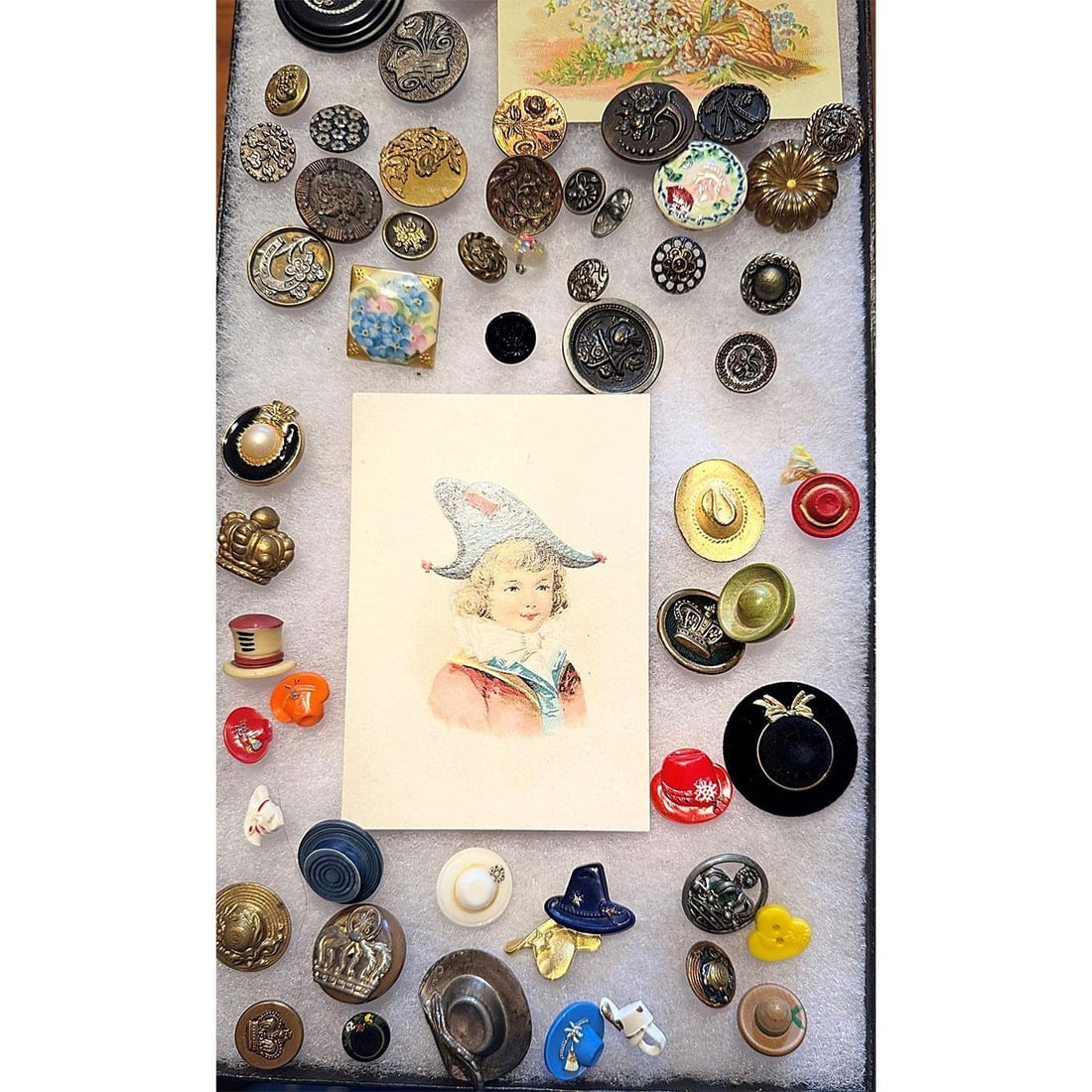 A Riker tray of assorted material buttons