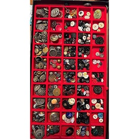A Riker tray of assorted material buttons