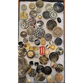 A Riker tray of assorted celluloid buttons