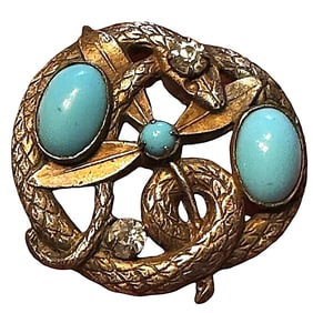 A division one pierced and jeweled snake button