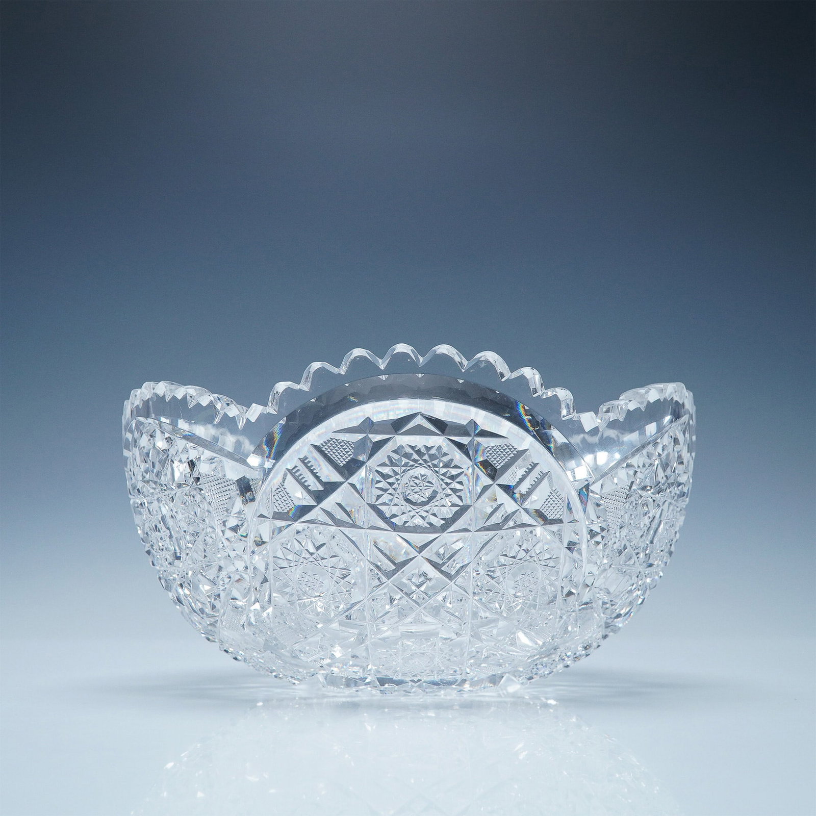 American Brilliant Cut Glass Bowl: A stunning American Brilliant Period cut glass bowl featuring an intricate geometric pattern of deeply cut hobstars, crosshatching, and fan motifs. The piece showcases the expert craftsmanship charact
