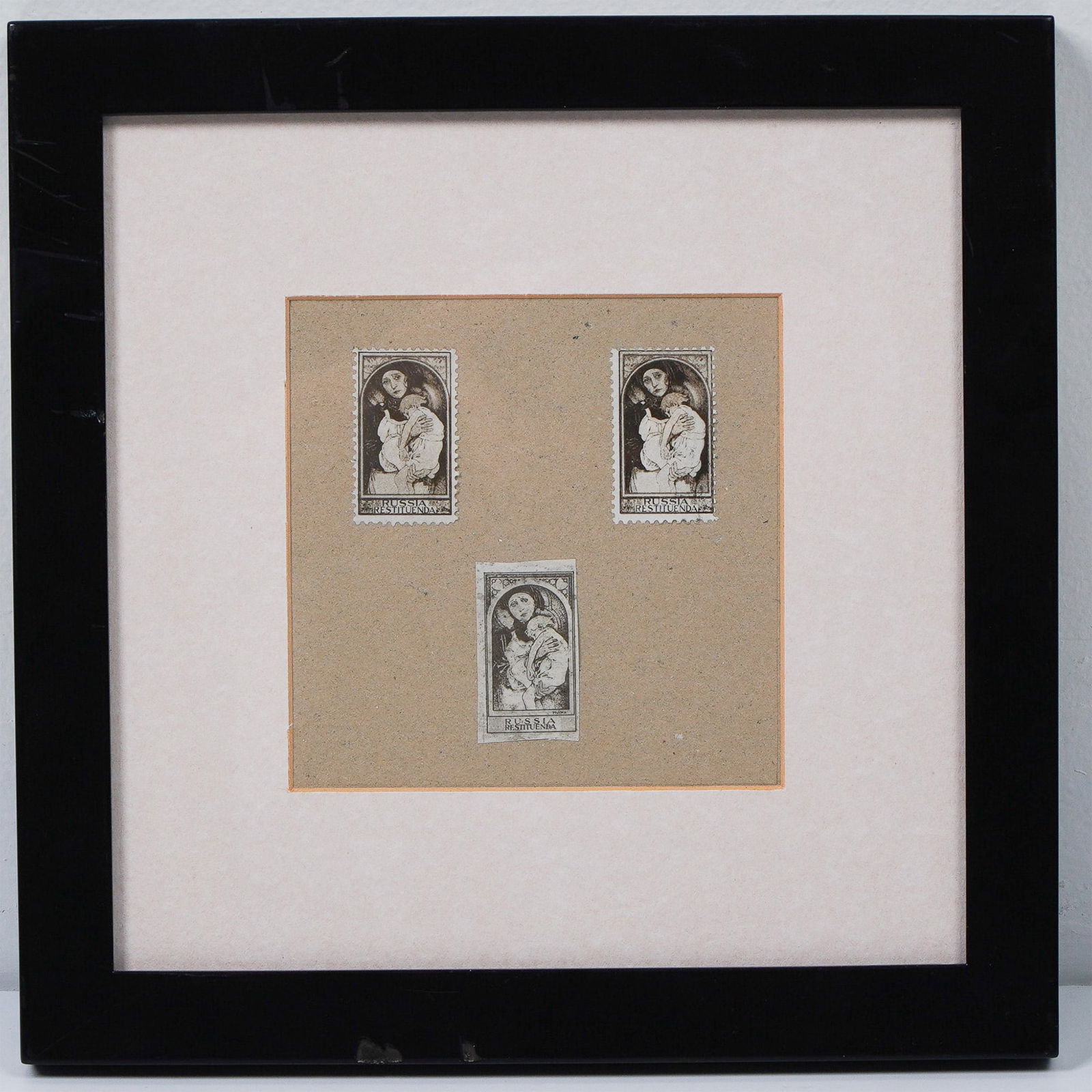 Alphonse Mucha Russia Restituenda Stamp Set: A framed display featuring three variations of the Russia Restituenda stamp, designed by Alphonse Mucha. These stamps replicate Mucha's original 1922 artwork, which symbolized the plight of Russia in