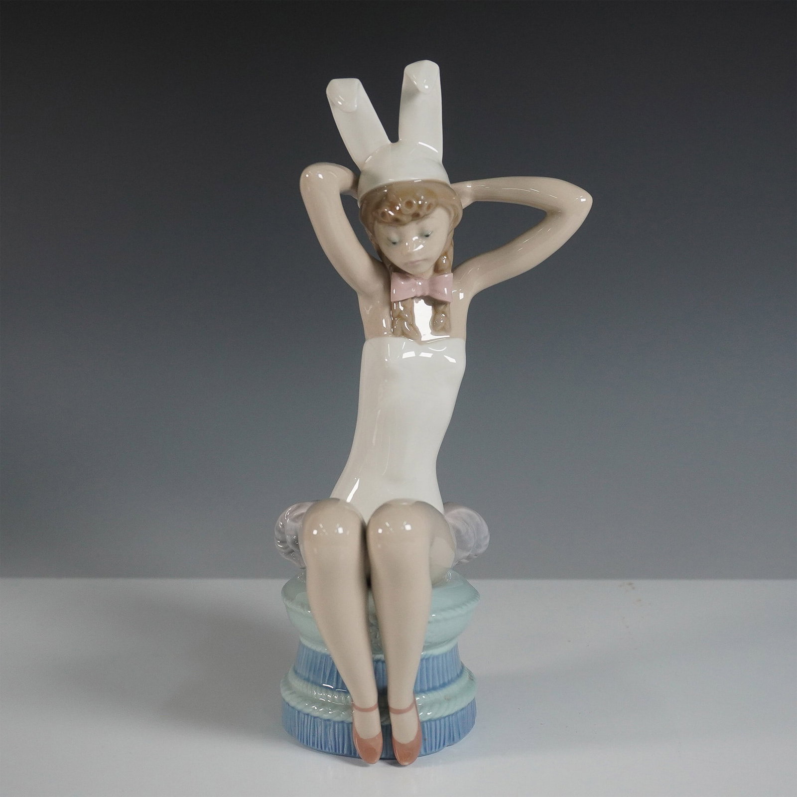 Lladro Porcelain Figurine, Bunny 0105163: Delightful Lladro porcelain figurine titled Bunny (model #01005163), designed by Salvador Debon. This charming piece features a young girl playfully dressed in a white bunny costume, complete with lon