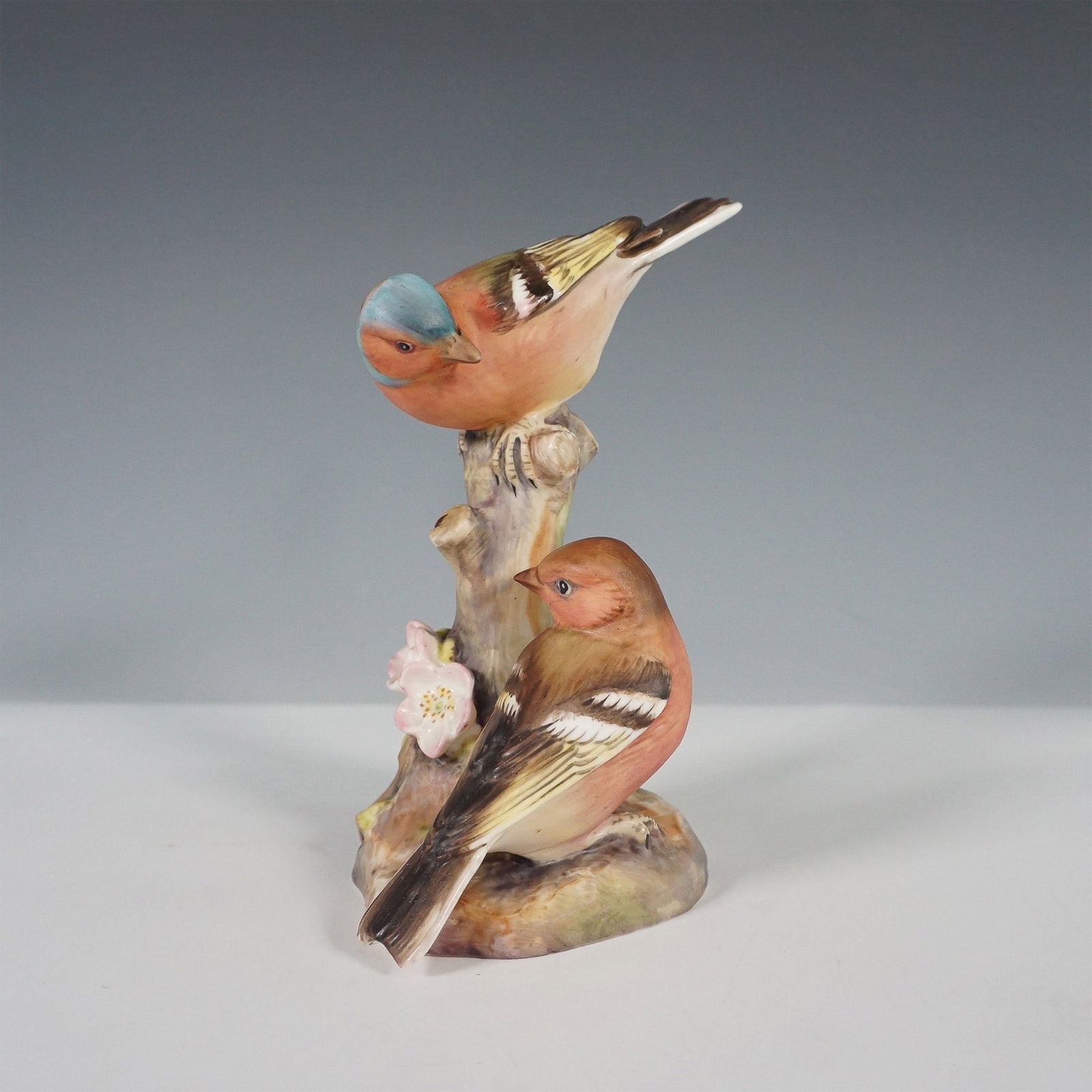 Royal Worcester Bone China Figurine, Chaffinches: Exquisite Royal Worcester bone china figurine featuring a pair of chaffinches perched on a delicately detailed tree stump adorned with blooming flowers. Model number 3364, this finely hand-painted pie