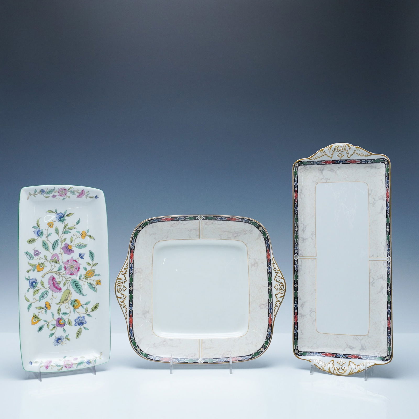 3pc Minton and Wedgwood Bone China Trays: This lot includes a collection of three bone china serving trays from Minton and Wedgwood. The collection features a Minton sandwich tray in the Haddon Hall pattern, decorated with a floral motif and