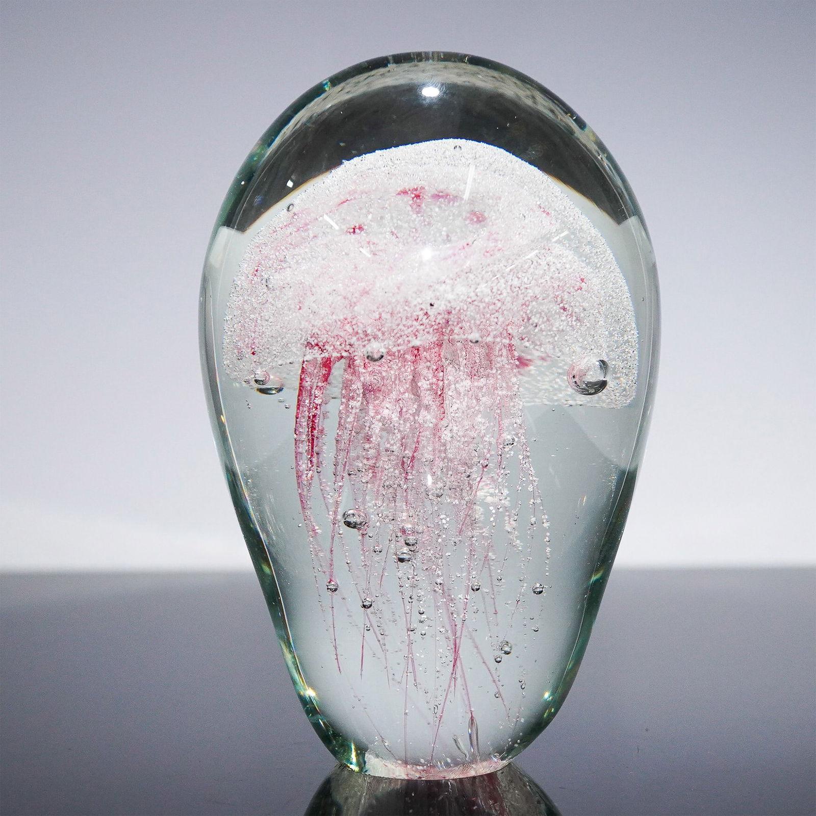 Art Glass Paperweight, Pink Jellyfish Design: Mesmerizing hand-crafted art glass paperweight featuring a stunning pink jellyfish suspended within a crystal-clear dome. This captivating design captures the delicate motion of jellyfish tendrils dri