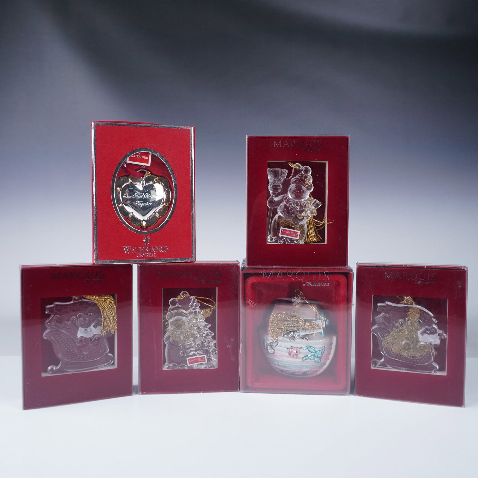 6pc Waterford Christmas Ornaments: A set of six Waterford ornaments, each in its original box. The set includes three 2012 Babys First Christmas ornaments, one 2012 Snowman ornament, one 2011 Snowman ornament, and one Our First Christm