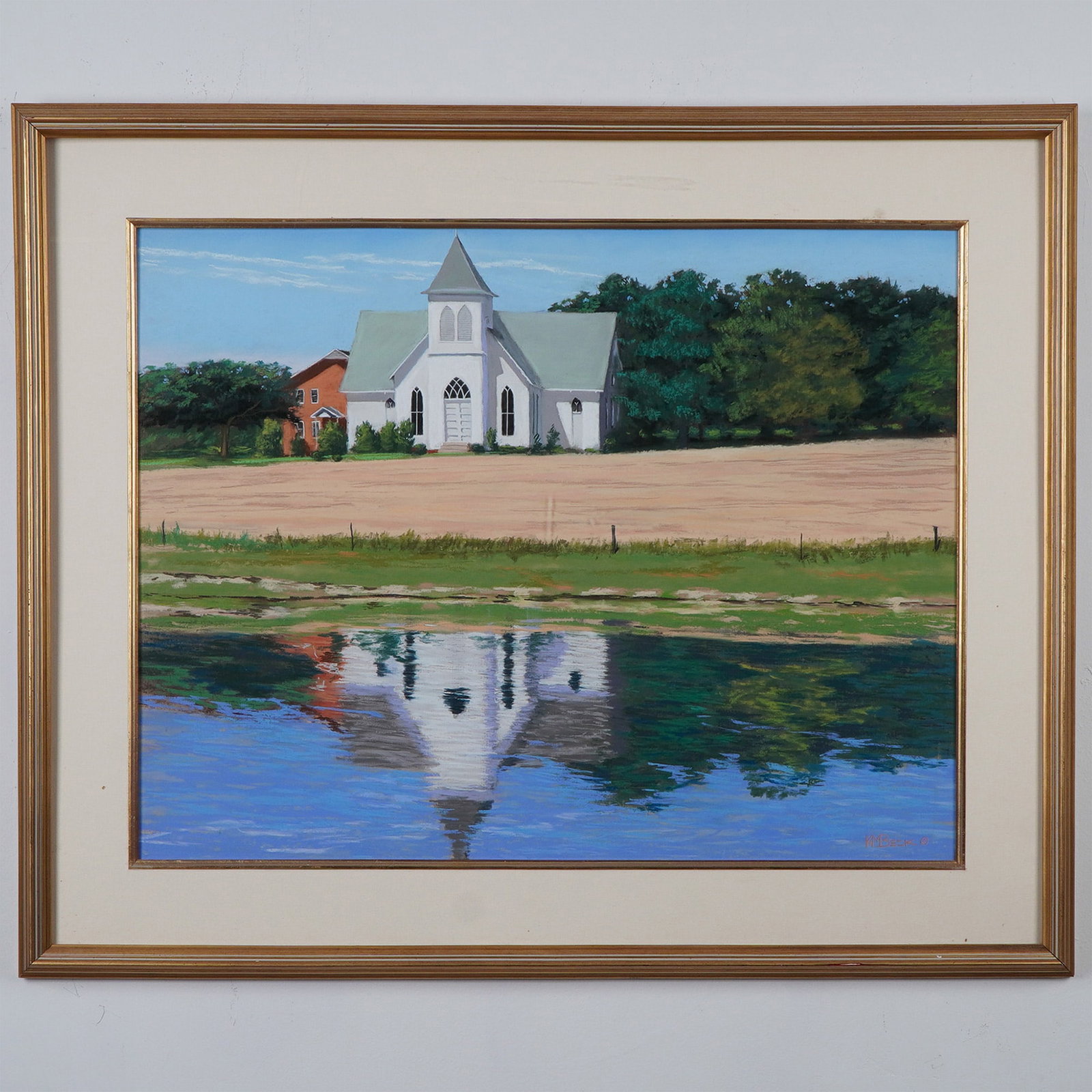 KM Beek Framed Pastel Landscape, Church Reflection: A serene pastel landscape by artist KM Beek, depicting a white church with its reflection mirrored in the calm waters below. This framed artwork beautifully captures the tranquility of the scene with 