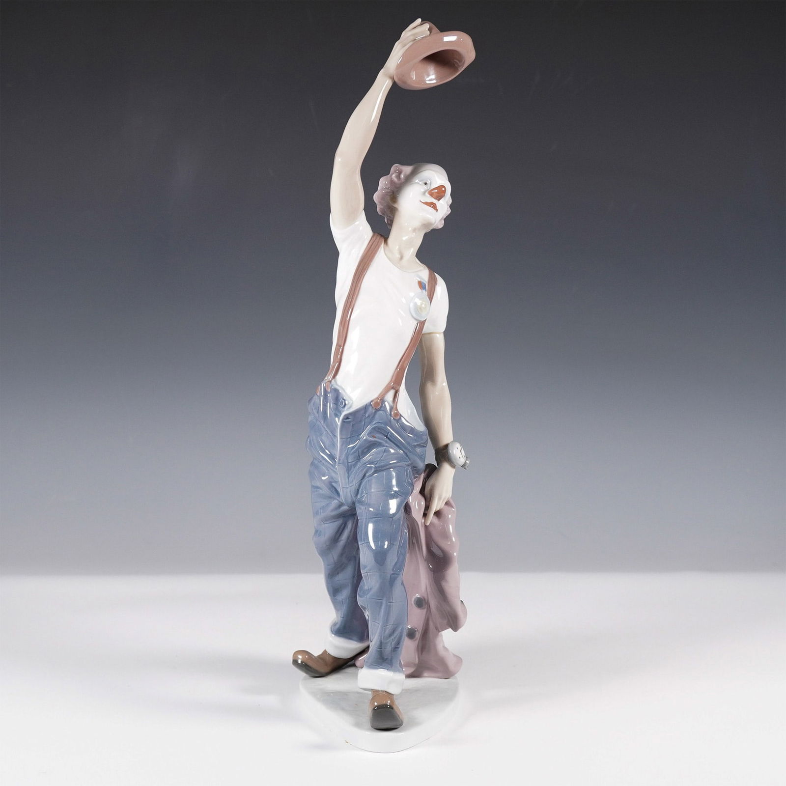 Lladro Porcelain Figurine, Hats Off To Fun 1005765: Presenting the whimsical Lladro porcelain figurine titled "Hats Off To Fun" (model number 1005765), masterfully sculpted by Salvador Furio. This enchanting piece captures the joyful essence of a clown
