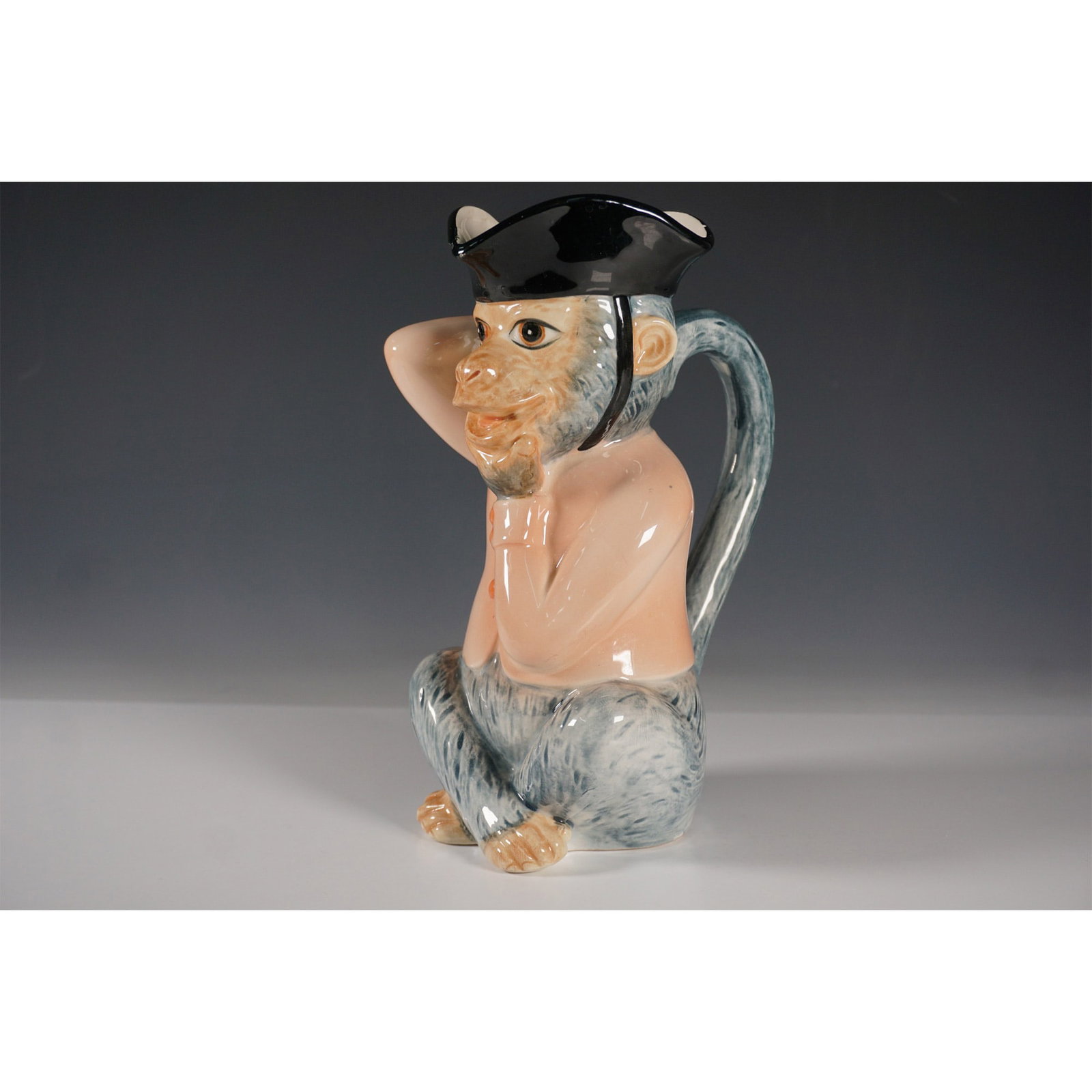 Hachiya Brothers Monkey Character Jug: A ceramic character jug by Hachiya Brothers, depicting a monkey wearing a tricorn hat, designed with a highly detailed and expressive face. The jug features a curved tail as the handle and is finished