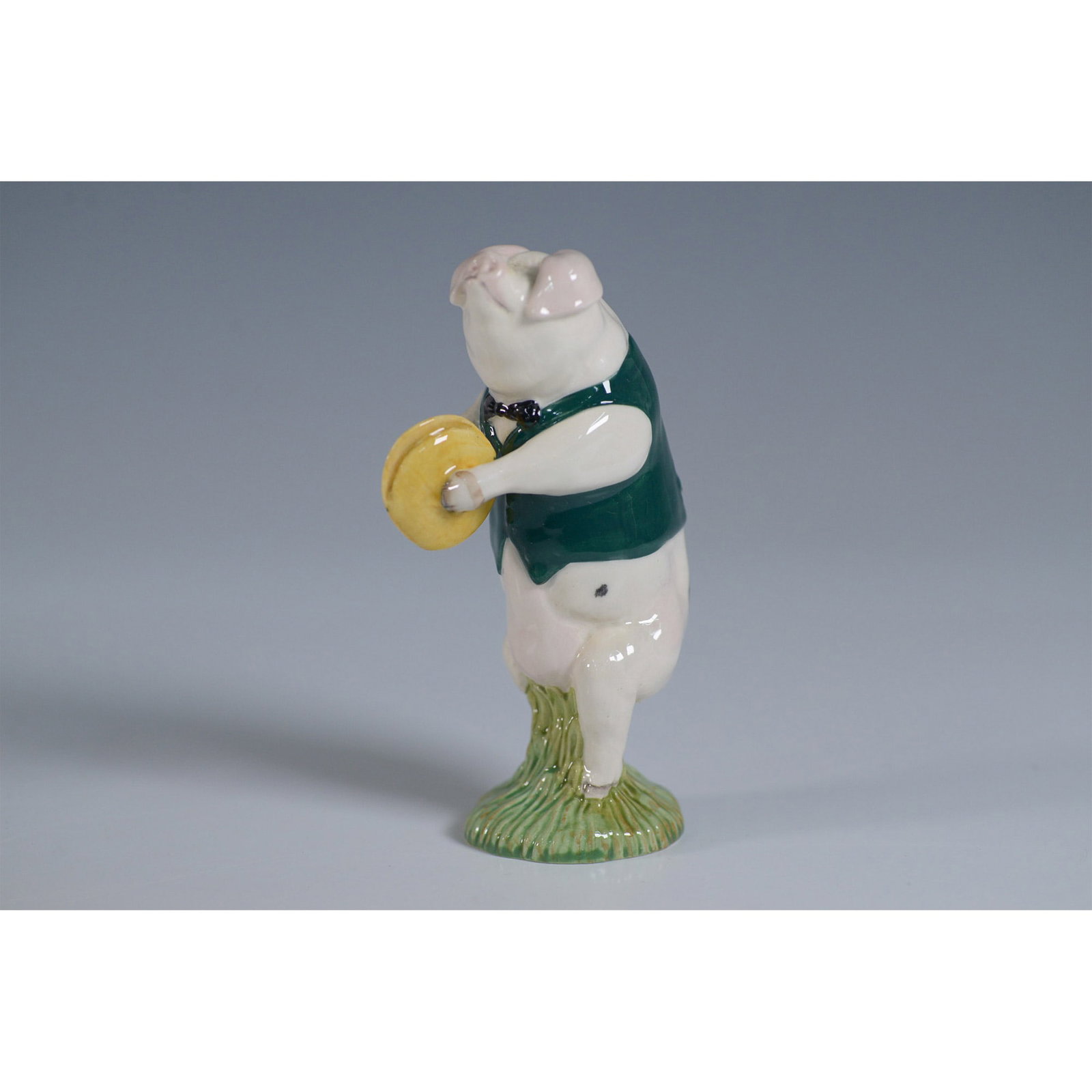 Beswick by Royal Doulton Figurine, George Cymbalist PP10: Charming Beswick by Royal Doulton porcelain figurine titled George Cymbalist, model PP10. This delightful hand-painted piece features a standing pig dressed in a green waistcoat and bow tie, holding a