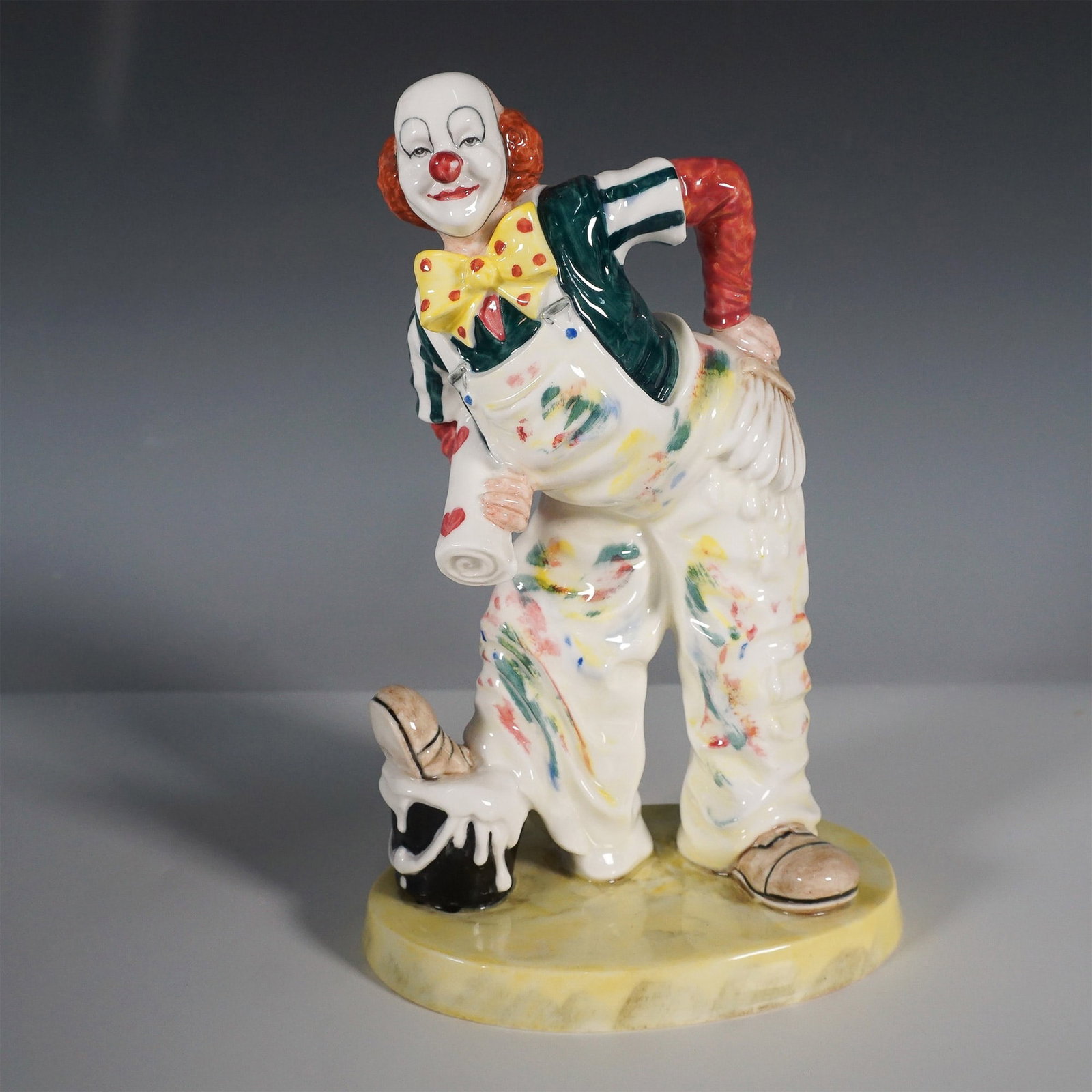 Coalport Cavalcade of Clowns Auguste Mishap Figurine: A whimsical Coalport fine bone china figurine titled Auguste's Mishap from the Cavalcade of Clowns series. This lively piece captures a mischievous clown in his classic attire, complete with suspender
