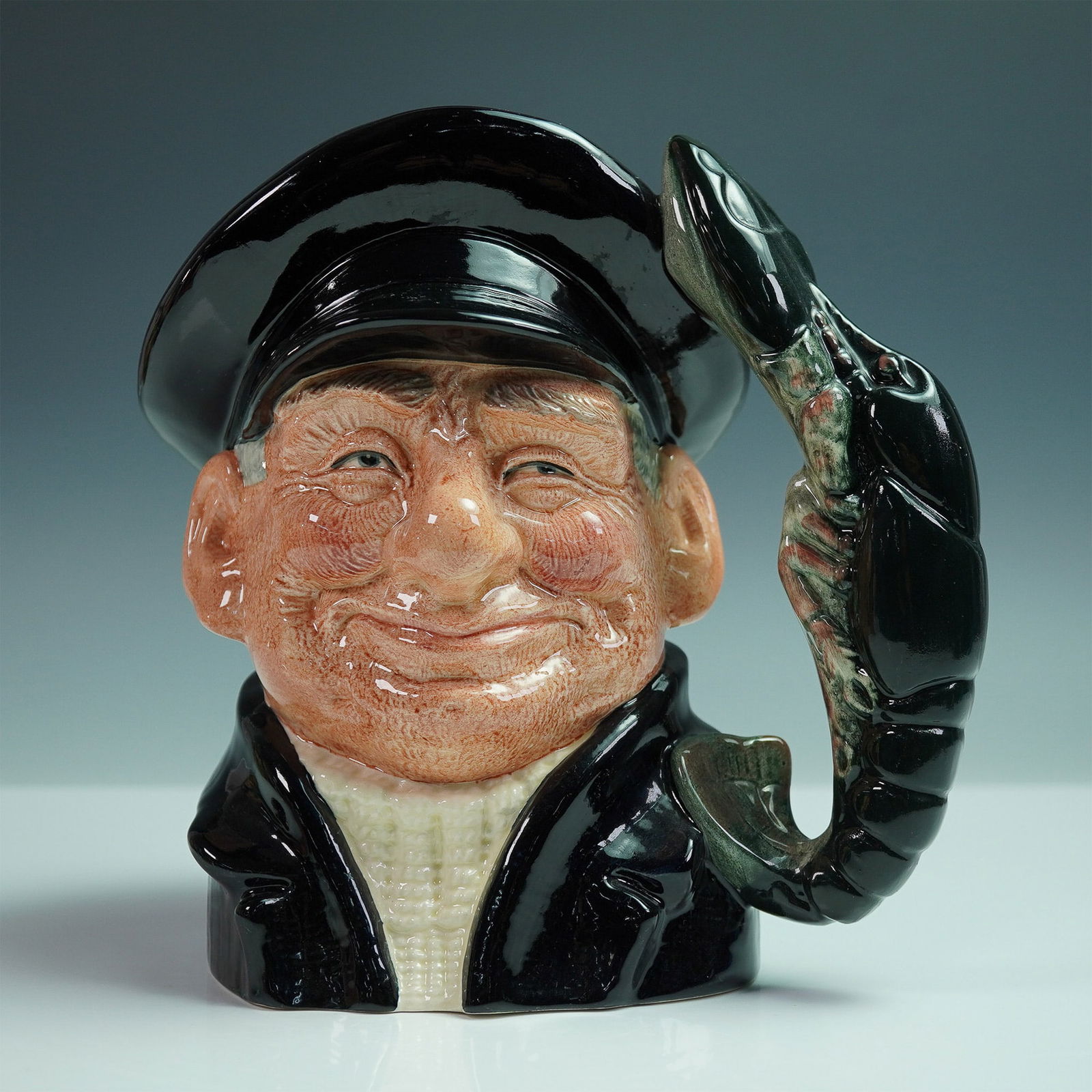 Royal Doulton Character Jug, Lobster Man D6617: Charming large character jug titled Lobster Man, model number D6617, designed by David B. Biggs and issued by Royal Doulton in 1968. This expressive ceramic jug features a cheerful fisherman with flus