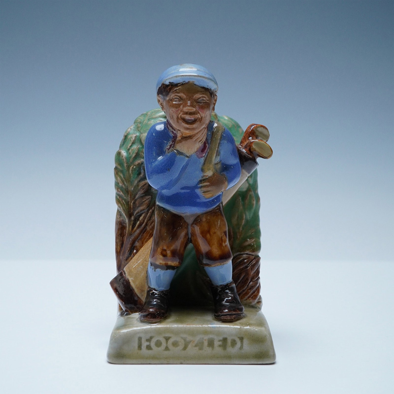 Doulton Lambeth Stoneware Bookend, Foozled: Foozled glazed stoneware bookend modeled by J. B. Harding. The term foozle means to botch or bungle, particularly in golf, where it refers to a badly executed shot. This bookend humorously captures a 