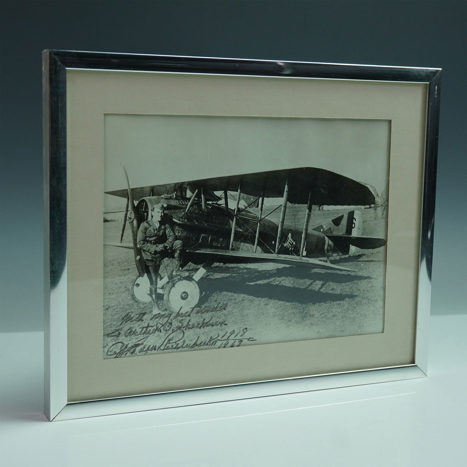 Framed Signed Photograph of Captain Eddie Rickenbacker with SPAD XIII: Offered here is a striking black and white photograph of legendary American World War I ace Captain Eddie Rickenbacker, shown seated beside a French SPAD XIII fighter plane—the very type he flew in