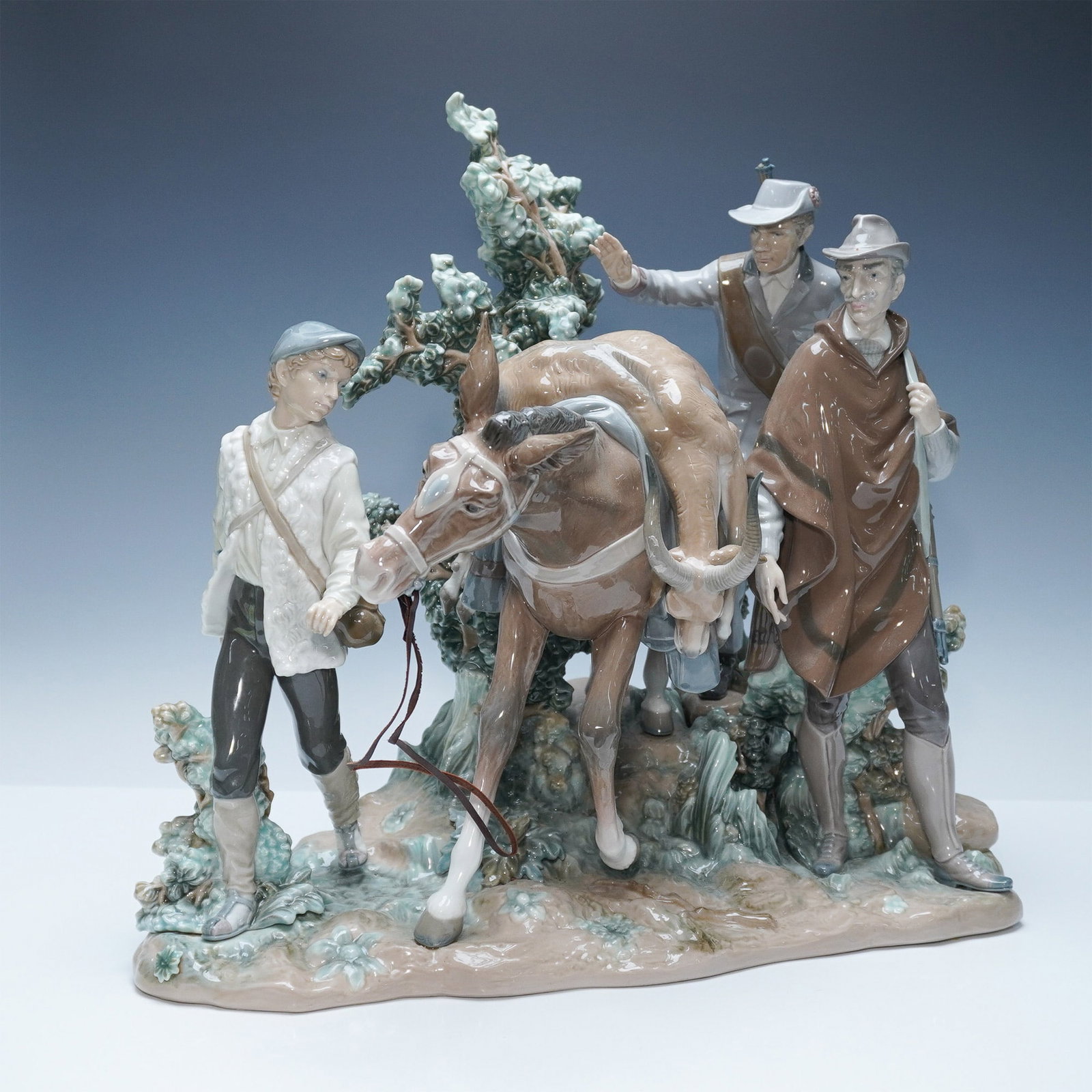 Lladro Successful Hunt Limited Edition Figurine 01005098: A striking Lladro Successful Hunt sculpture, depicting a group of hunters guiding their horse through a lush, natural setting. This intricately detailed limited-edition piece features expressive figur