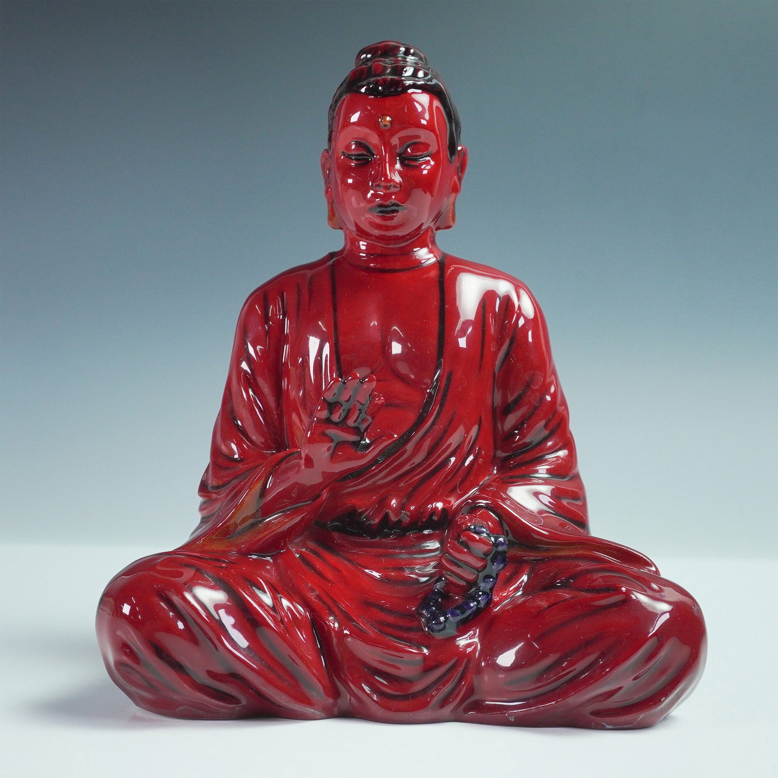 Royal Doulton Flambe Sung Figurine, Guizhou Buddha BA60: Part of the Asian Heritage series and the Burslem Artwares collection. Crafted from fine bone china, it showcases the striking flambe glaze, a technique renowned for its rich, deep red tones. Royal Do