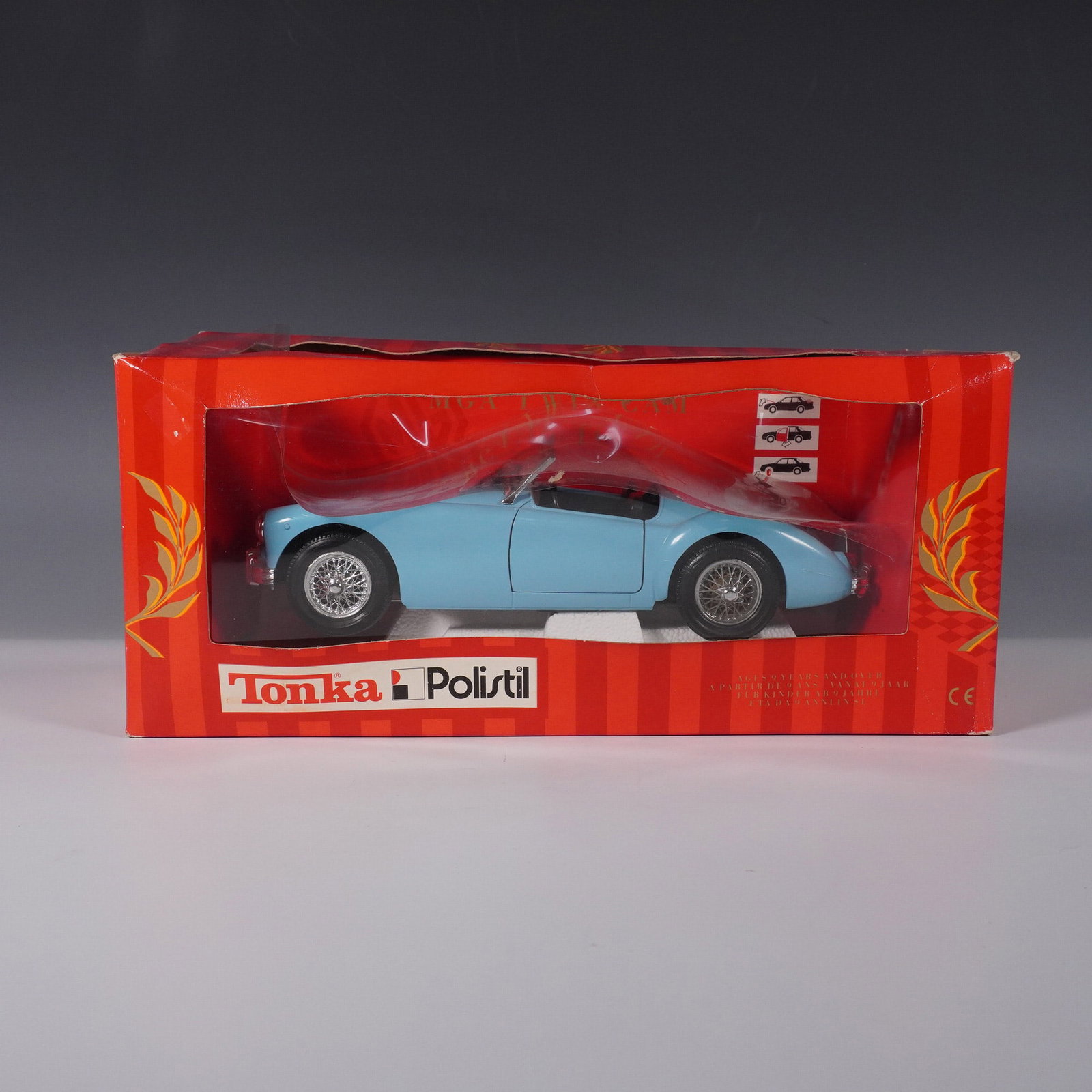 Tonka Polistil Diecast 1:18 Lancia B24 Spider: This Tonka Polistil 1:18 scale diecast model features a Lancia B24 Spider in a striking light blue finish. Produced with fine attention to detail, this collectible model includes intricate wire wheels