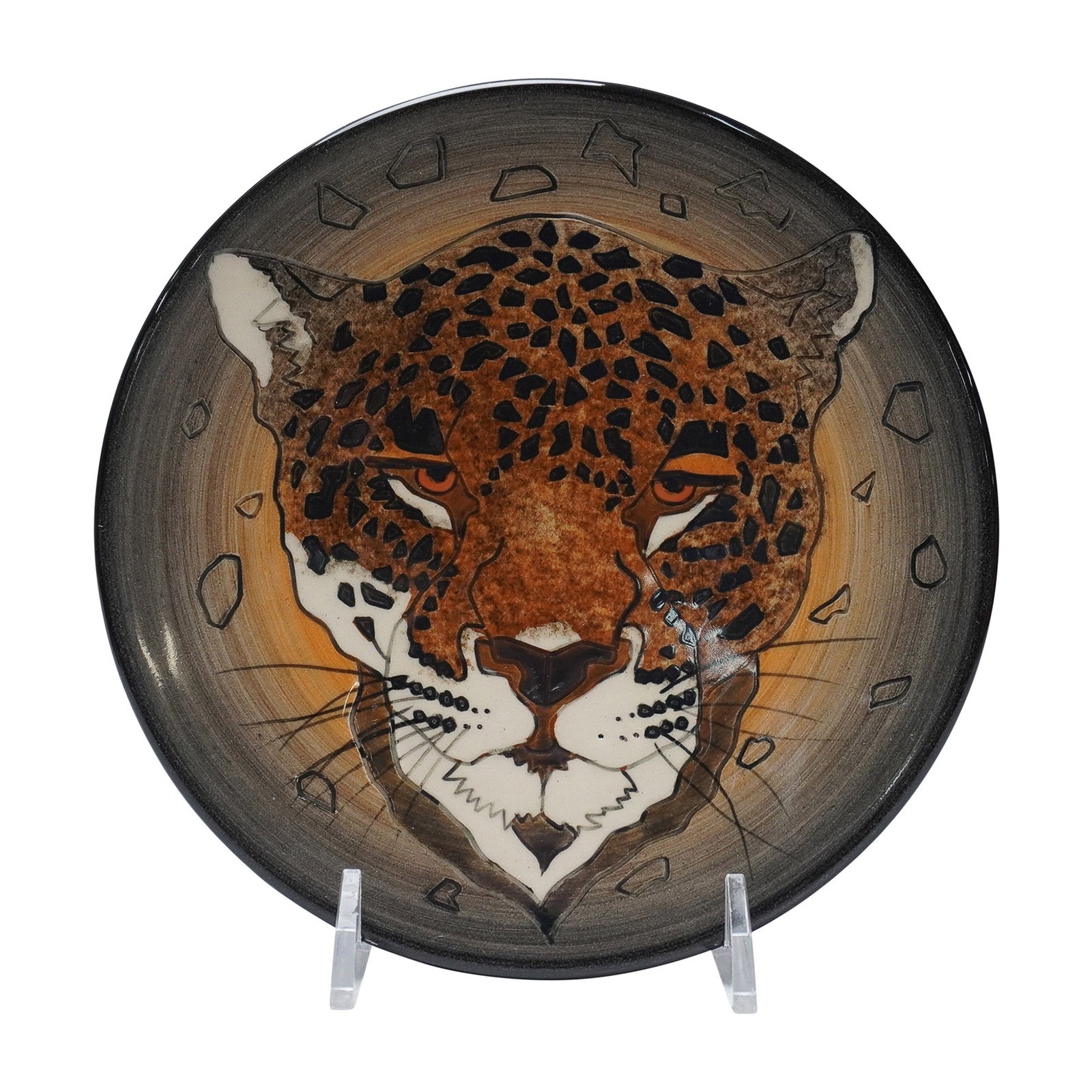 Dennis Chinaworks Sally Tuffin Plate, Leopard: Dennis Chinaworks earthenware plate featuring a hand-decorated leopard motif, designed by Sally Tuffin. The stylized depiction centers on a frontal view of the animal's face, with hand-painted spotted
