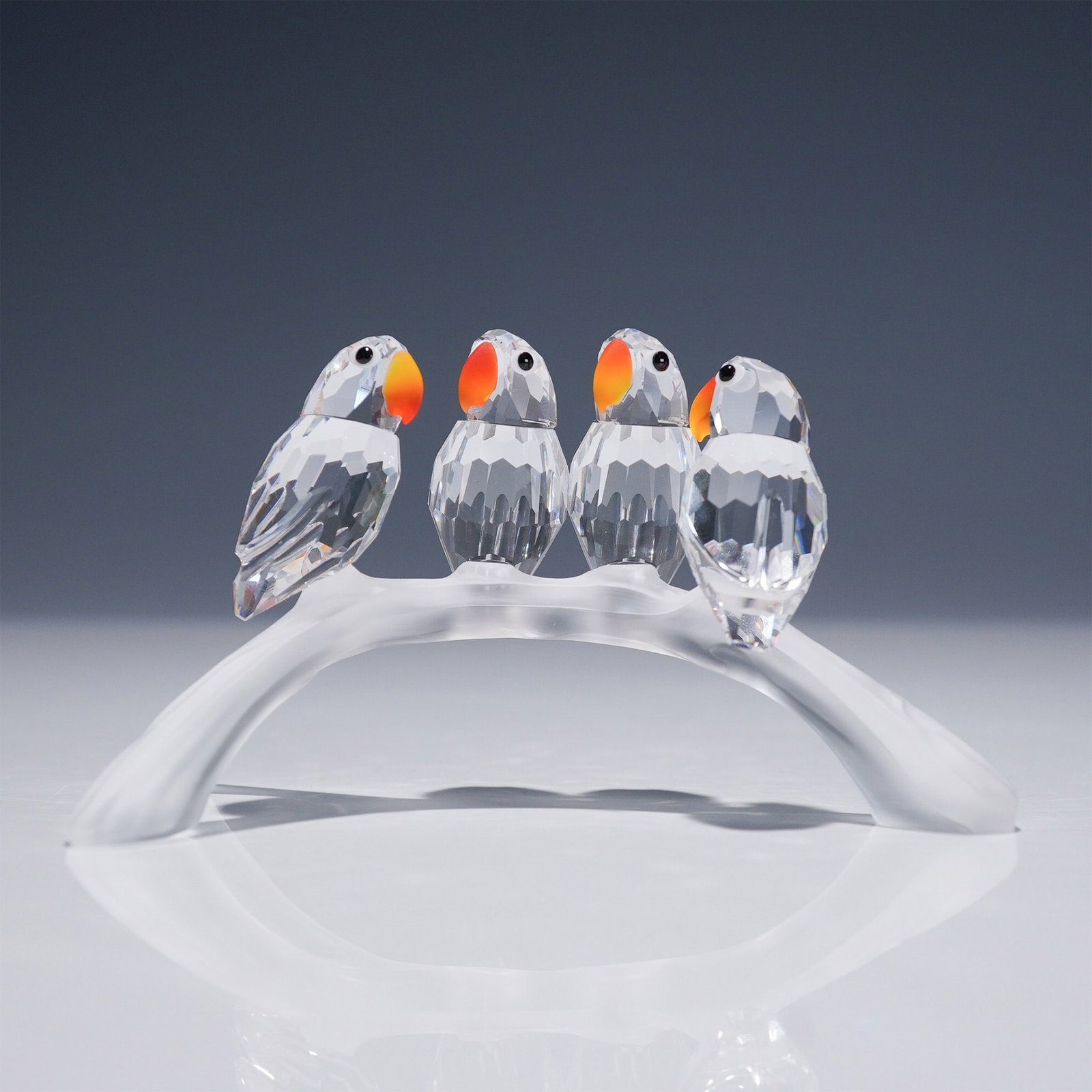 Swarovski Crystal Figurine, Baby Lovebirds: Charming Swarovski crystal figurine titled Baby Lovebirds, designed by Adi Stocker. Introduced in 1996 and retired in 2011, this now-discontinued piece is part of the "Feathered Beauties" theme. The d