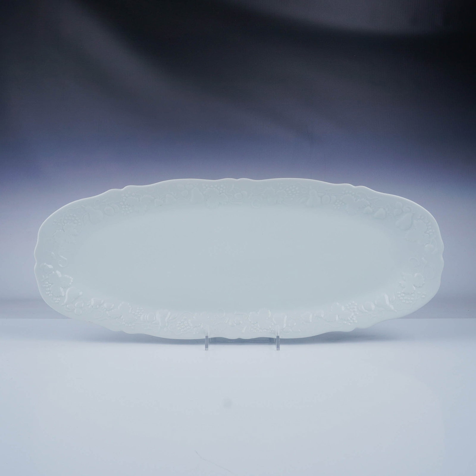 Philippe Deshoulieres Platter, California - Blanc De Blanc: This elegant porcelain fish platter is crafted in the California Blanc De Blanc pattern. The design features a pristine all-white finish adorned with intricate embossed fruit and leaf motifs along the