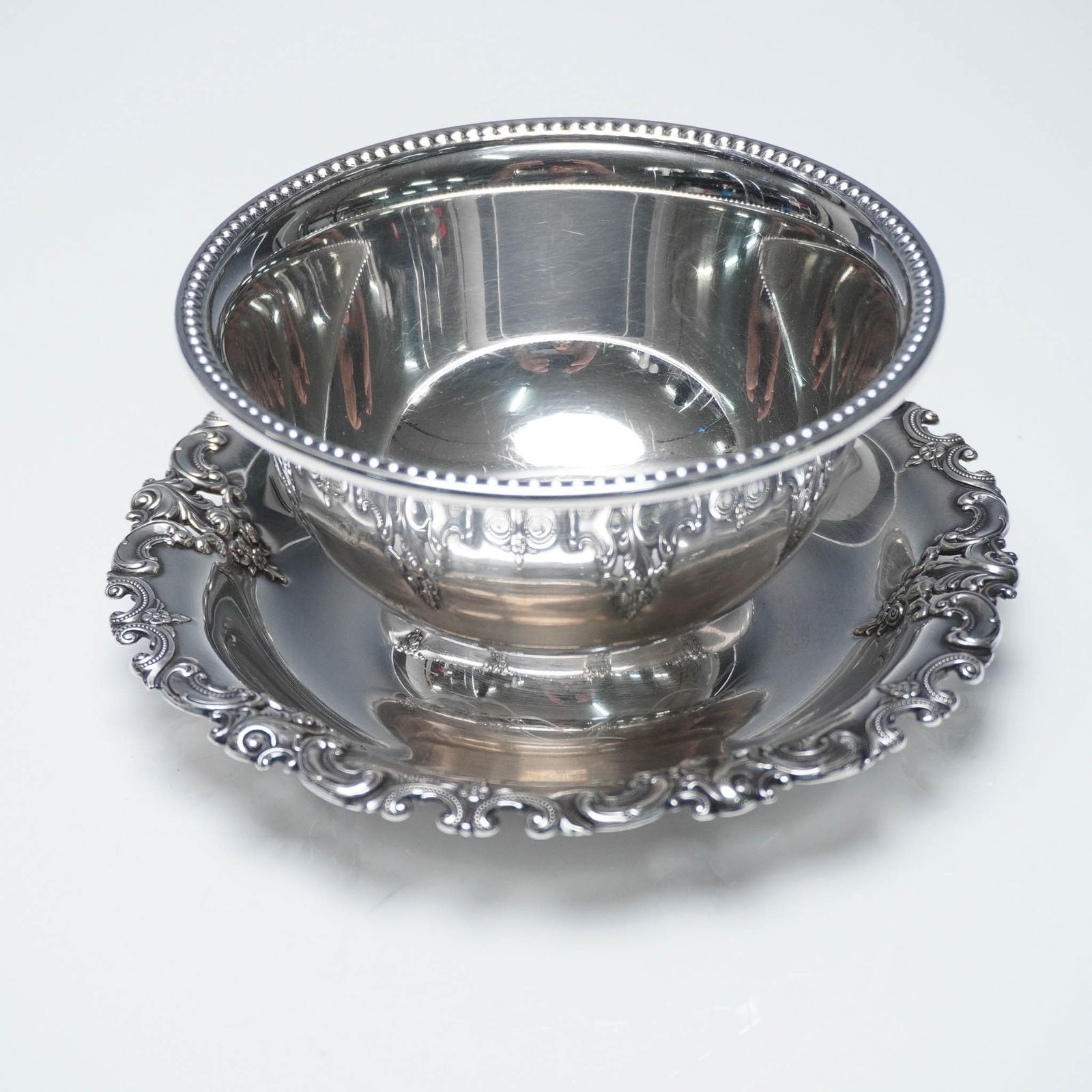Wallace Sterling Silver Gravy Bowl with Attached Underplate, Grande Baroque: This sterling silver gravy bowl with an attached underplate by Wallace Silversmiths is crafted in the Grande Baroque pattern, one of the most celebrated and ornate designs in American silverware. The