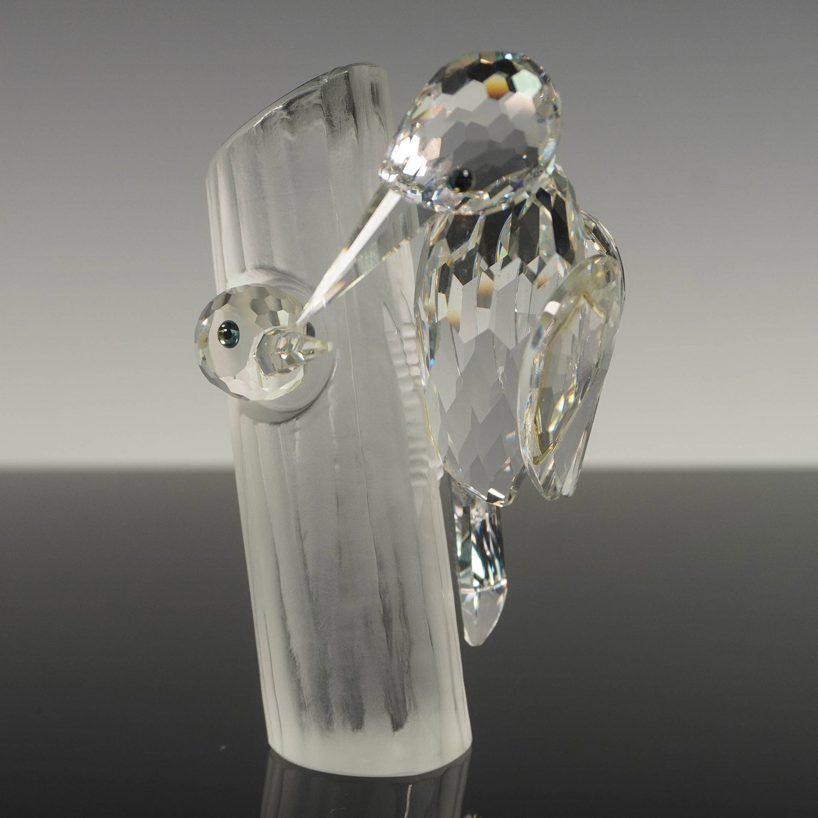 Swarovski Crystal Woodpeckers Figurine, Sharing: Swarovski crystal 1988 Annual Edition Sharing figurine featuring two faceted clear crystal woodpeckers perched on a frosted crystal tree trunk. The birds are rendered with meticulous detail, including