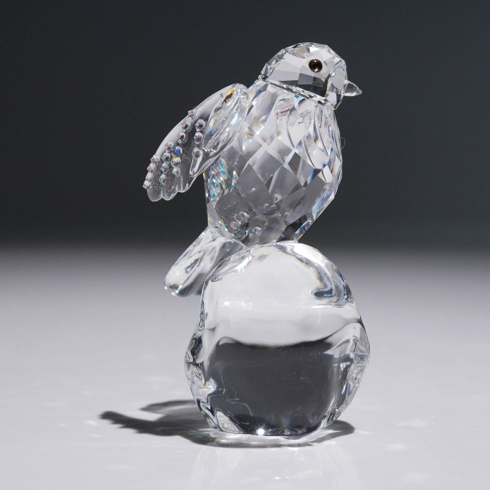 Swarovski Robin Winter Sparkle Figurines: A beautifully crafted Swarovski crystal figurine titled Robin Winter Sparkle, model number 5464880, designed by Tord Boontje in 2019. This charming piece features a faceted clear crystal robin perched