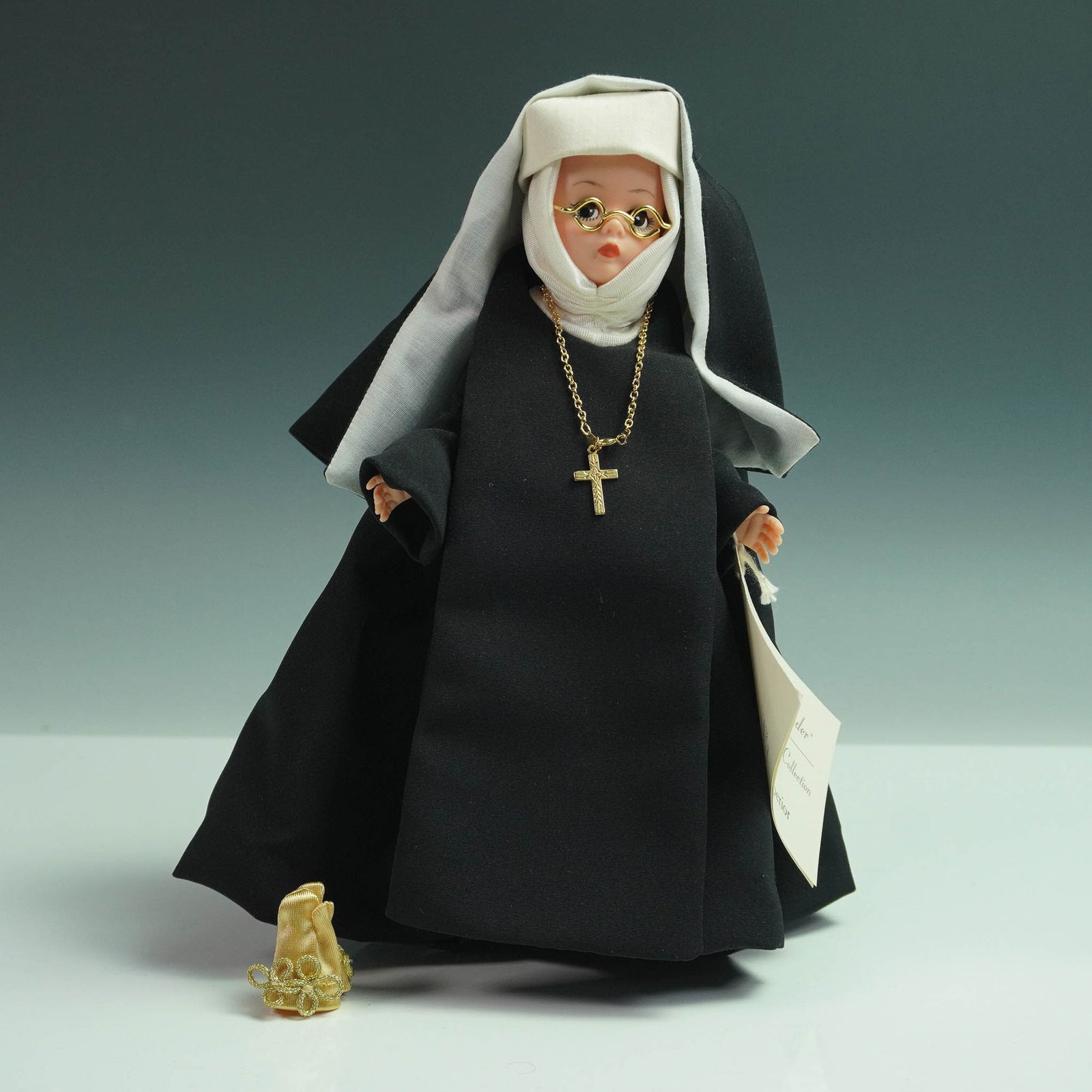 Madame Alexander Doll, Mother Superior with Box: Madame Alexander Mother Superior doll from The Sound of Music collection. The doll features a full black and white habit, gold cross necklace, eyeglasses, and includes a golden crown accessory. Comes