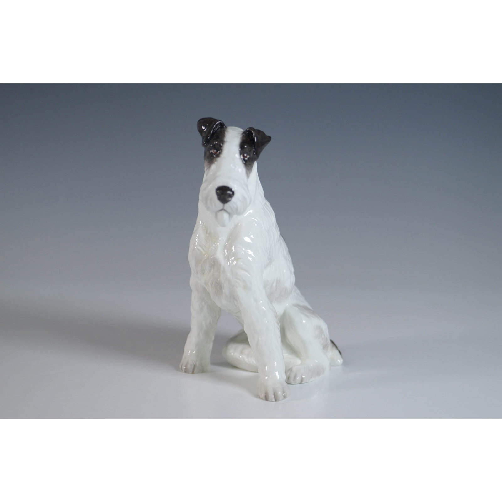 Royal Staffordshire Figurine, Wirehaired Fox Terrier: Royal Staffordshire English Bone China figurine featuring a Wirehaired Fox Terrier in a seated pose. This finely detailed figurine showcases a lifelike depiction with black and white fur accents. The 