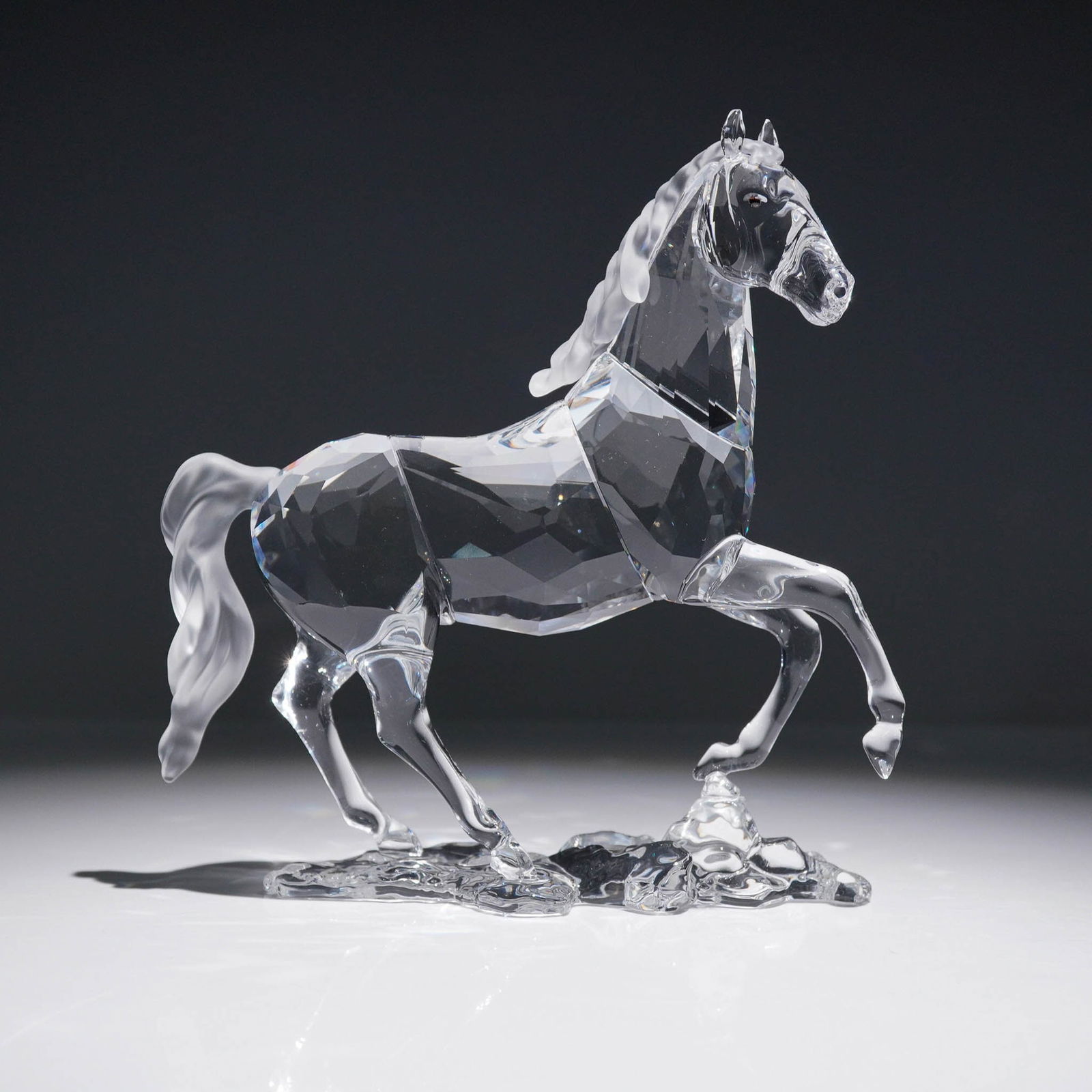 Swarovski Crystal Figurine, Stallion: Crafted in clear crystal with a faceted body and frosted mane and tail, the horse is depicted mid-stride atop a clear crystal base evoking movement through water. This elegant design celebrates the be
