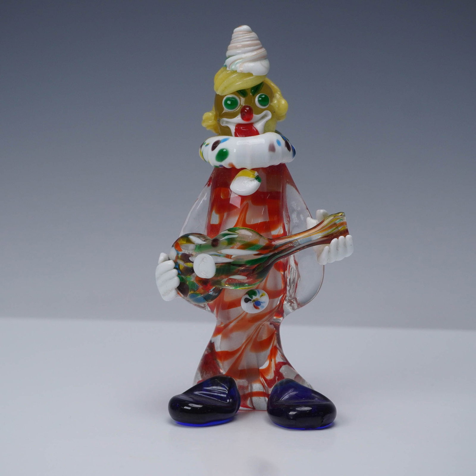 Murano Art Glass Whimsical Clown: Colorful hand-blown Murano glass clown figurine crafted in Italy, imported by J.I Co during the mid 1950s thru the early 1970s. This cheerful figure features multicolored millefiori details, a red and