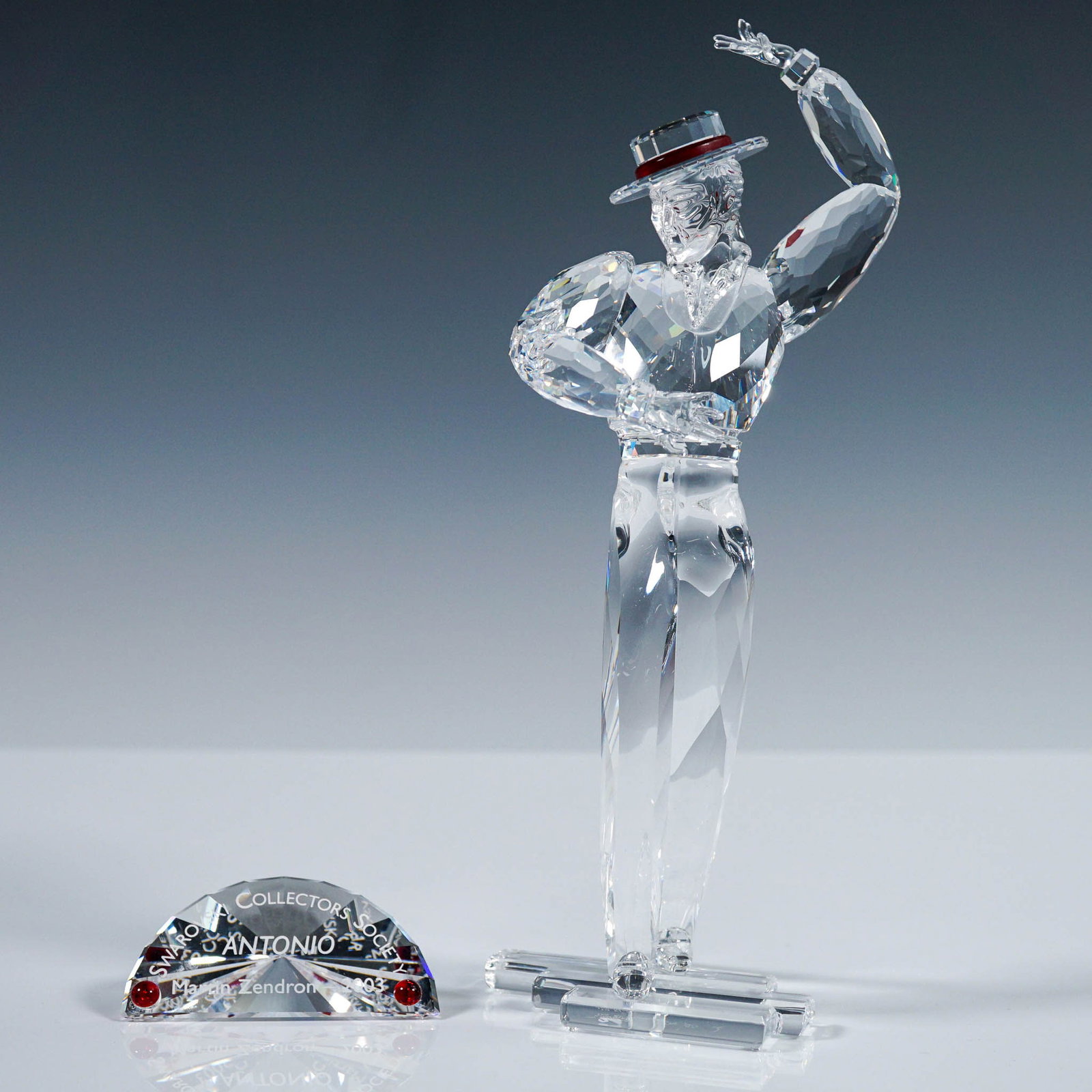 2pc Swarovski Crystal Figurine, Magic of Dance - Antonio with Plaque: Striking Swarovski crystal figurine titled Antonio, issued in 2003 as the second installment in the Magic of Dance trilogy. Designed by Martin Zendron, Antonio is portrayed in mid-dance, capturing the