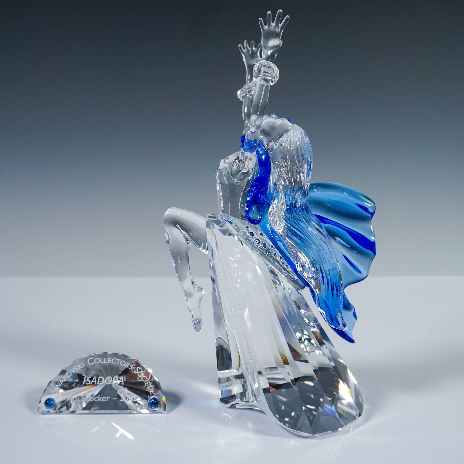 2pc Swarovski Crystal Figurine, Magic of Dance Isadora with Plaque: A striking Swarovski Crystal figurine from the Magic of Dance trilogy, titled Isadora, issued in 2002 exclusively for Swarovski Crystal Society members. This limited edition piece was designed by Adi 