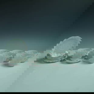 12pc Arabia Oksa Rice Grain Porcelain Cups and Saucers: A 12-piece porcelain tea set in the Oksa rice grain pattern by Arabia of Finland, designed by Friedl Holzer-Kjellberg. This refined mid-century set includes six cups and six matching saucers, each sho