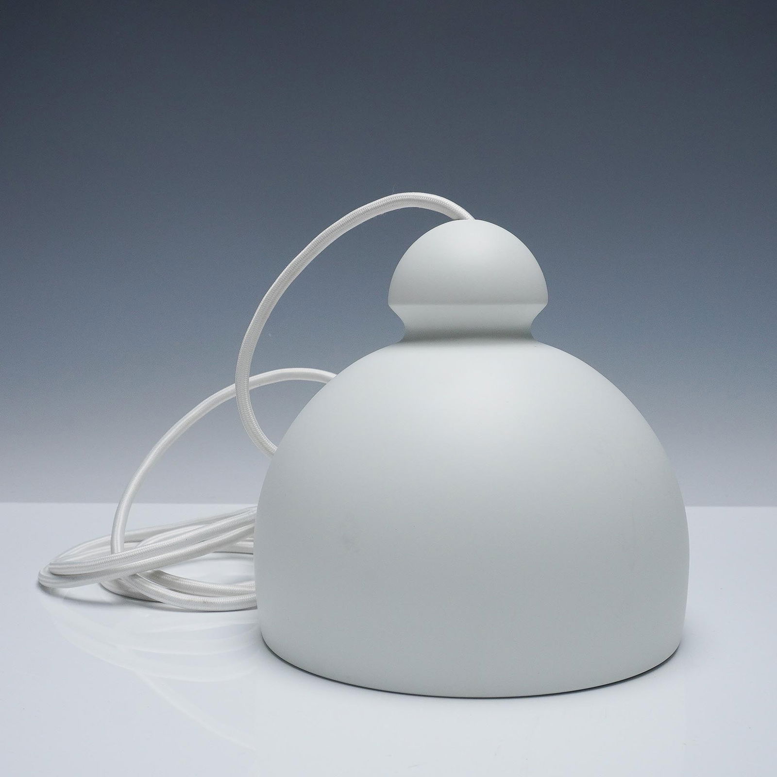 Le Klint Modern White Dome Pendant Light: An elegant and refined table lamp from Danish design house Le Klint. The minimal design offers a soft, diffused glow. Includes white fabric-wrapped wiring and interior support ring with mounting arms.