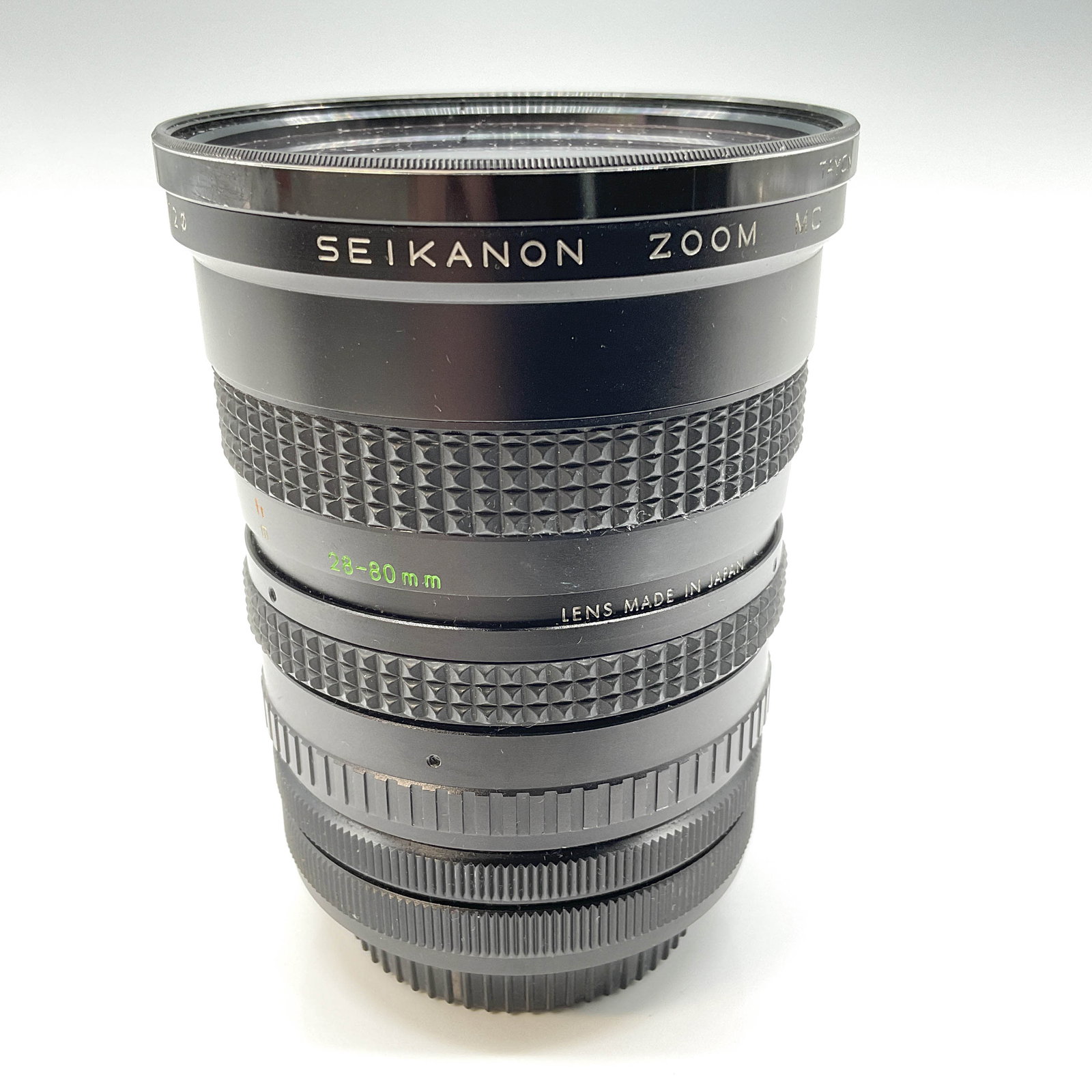 Seikanon 28-80mm Macro Zoom Lens, Made in Japan, 4.25"H: Vintage Seikanon Zoom Lens, 1:3.5-4.5, with a focal range of 28-80mm and macro capability. Marked "Made in Japan," this lens features manual zoom and aperture adjustments, making it ideal for photogra