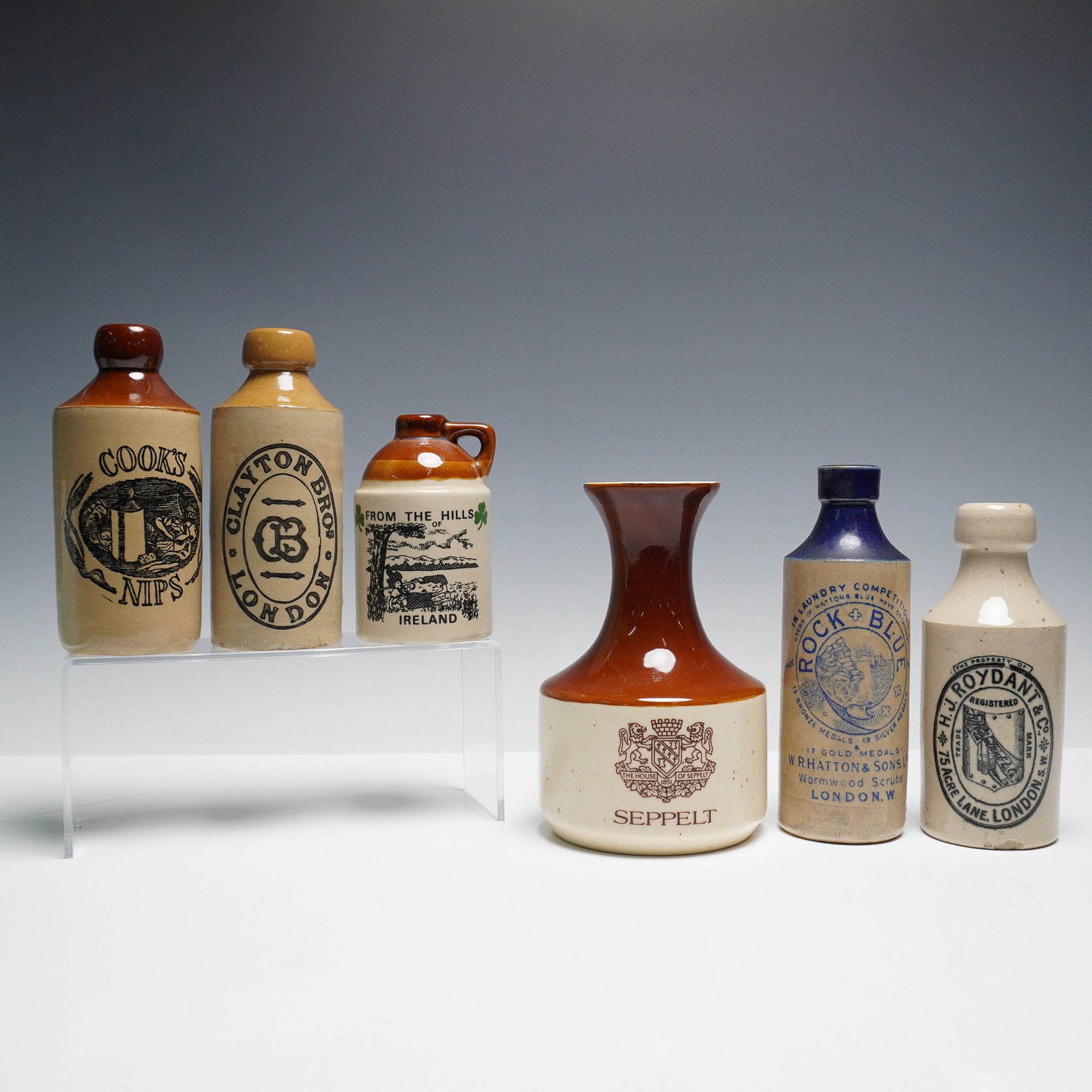 6pc Vintage Stoneware Bottles & Jugs, UK Ireland Australia: Collection of six vintage stoneware bottles and jugs featuring advertising from England, Ireland, and Australia. Includes pieces marked ?Clayton Bros,? ?Cook?s Nips,? ?Rock Blue,? ?H.J. Roydant & Co,?