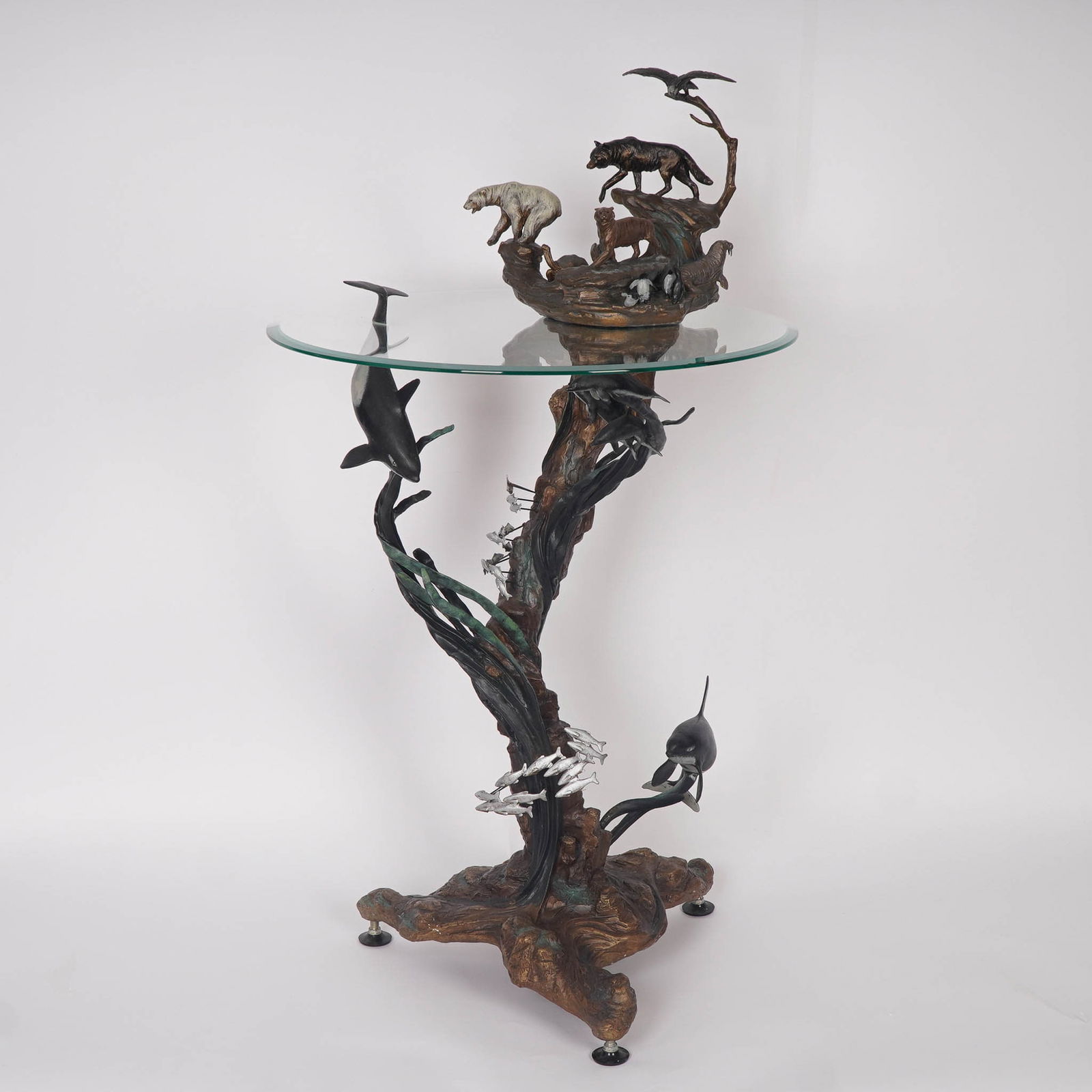 Steven D. Lord for Franklin Mint, Table, Guardians of the World, Stamped: This exquisite Guardians of the World table by Franklin Mint features a bronze base intricately sculpted by artist Steven Lord, depicting a harmonious assembly of wildlife including wolves, polar bear