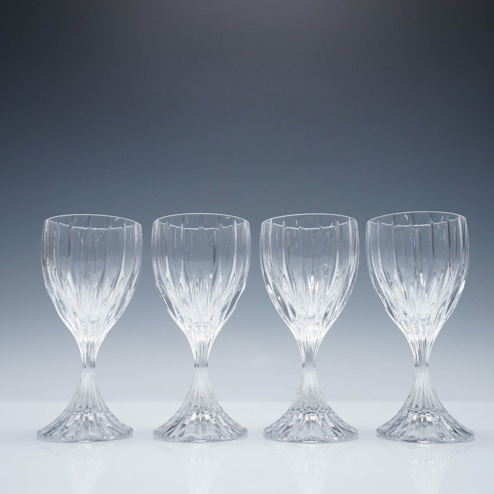 4pc Mikasa Crystal Wine Glasses, Park Lane: Set of four crystal glasses featuring a vertically paneled bowl and flared foot. The elegant faceted pattern enhances light refraction, giving the glasses a refined sparkle. The Park Lane pattern is r