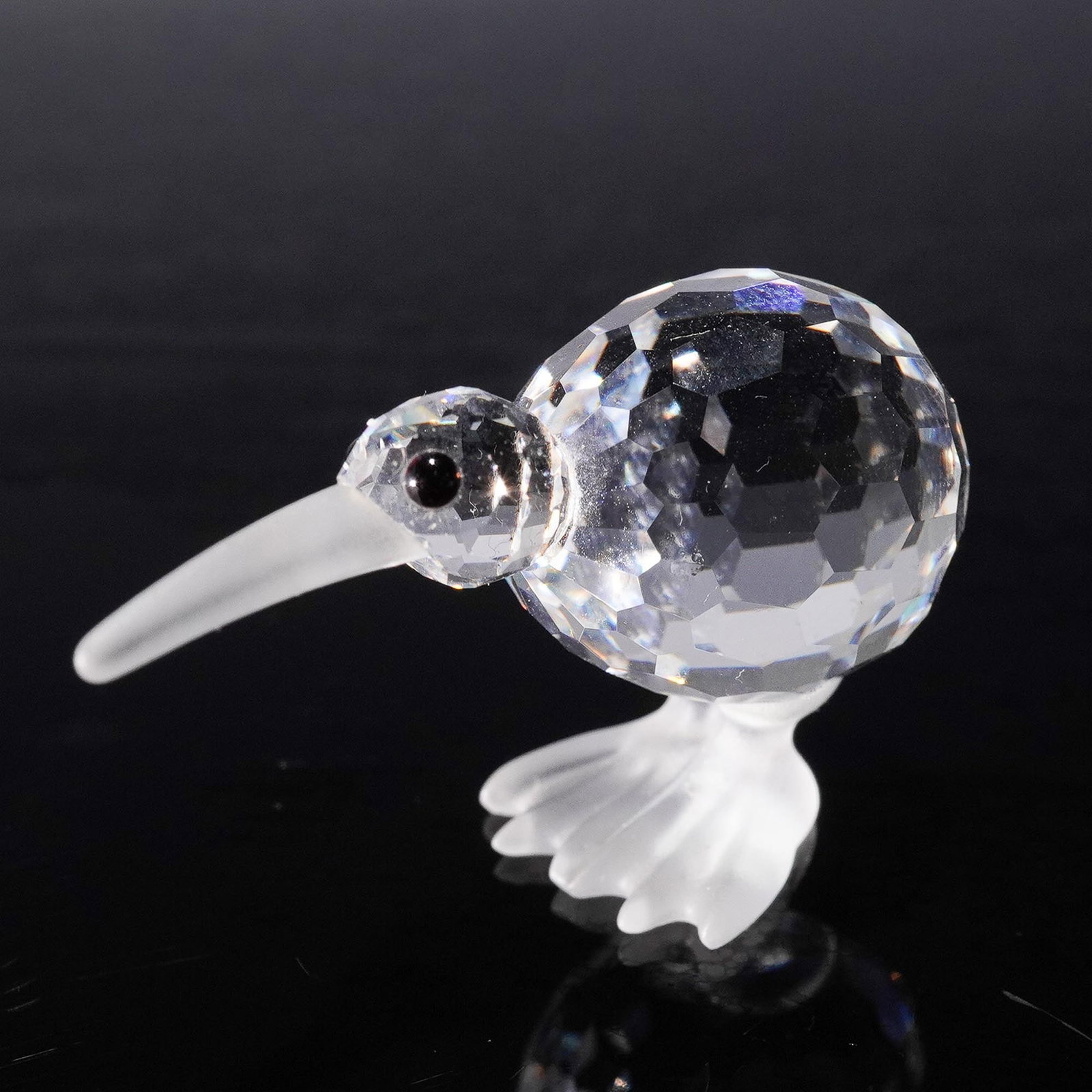 Swarovski Crystal Figurine, Kiwi Bird: Whimsical Swarovski Silver Crystal kiwi bird figurine designed by Michael Stamey, introduced in 1991 and retired in 1996. This delightful piece features a fully faceted clear crystal body paired with 