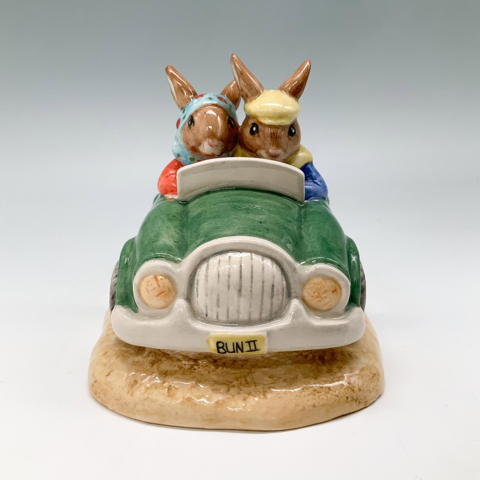 Royal Doulton Bunnykins Figurine, Day Trip Bunnykins DB260: Royal Doulton Bunnykins figurine titled Day Trip Bunnykins, DB260. This lovely figurine features two bunnies in a green car, with the license plate BUN II. Hand-made and hand-decorated, this piece was