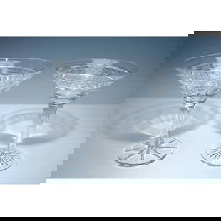 2pc William Yeoward Crystal and Other Cut Glass Martini Glasses: Pair of martini glasses including one by William Yeoward crystal in the Georgia pattern, featuring a cut laurel motif around the bowl and a starburst base. Accompanied by a clear-glass martini glass w