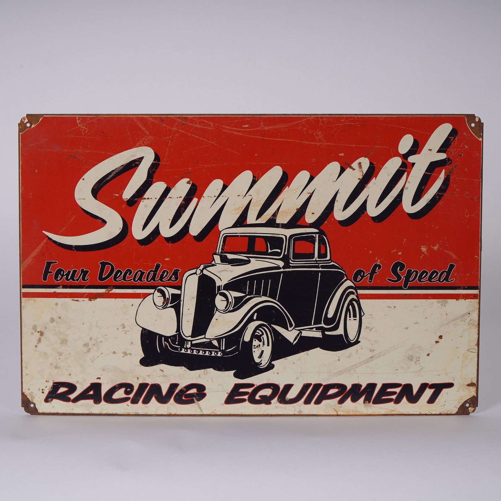 Summit Racing Equipment Tin Sign: Vintage-style Summit Racing Equipment tin sign featuring bold retro graphics with a classic hot rod and the slogan Four Decades of Speed. The vibrant red, cream, and black color palette delivers insta